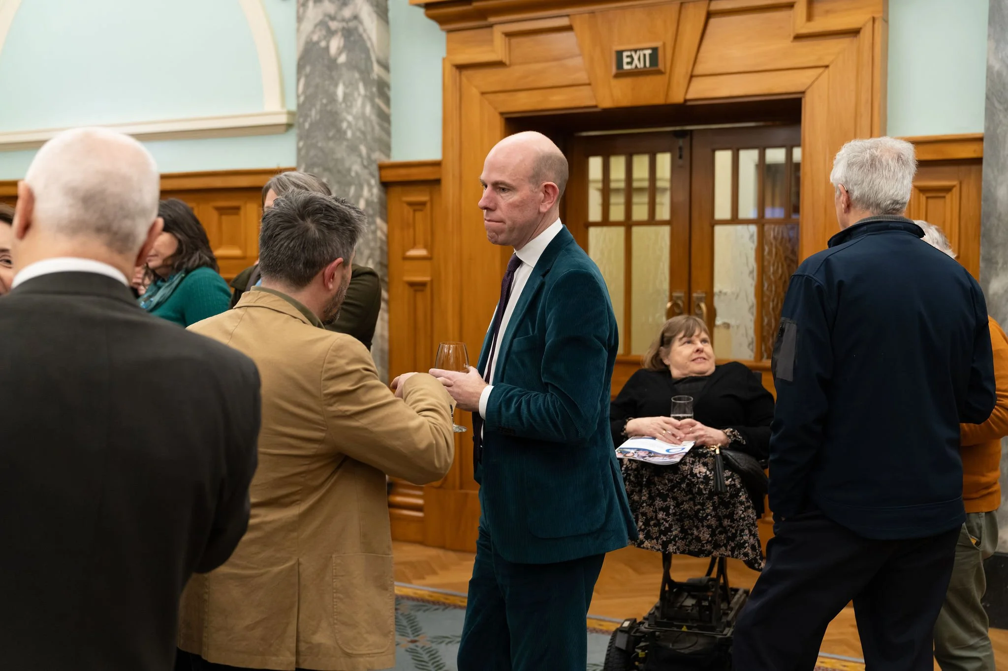 People in formal dress mingling.