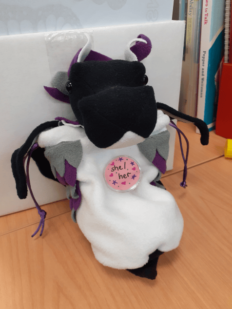 Toy cow with pronoun badge.png