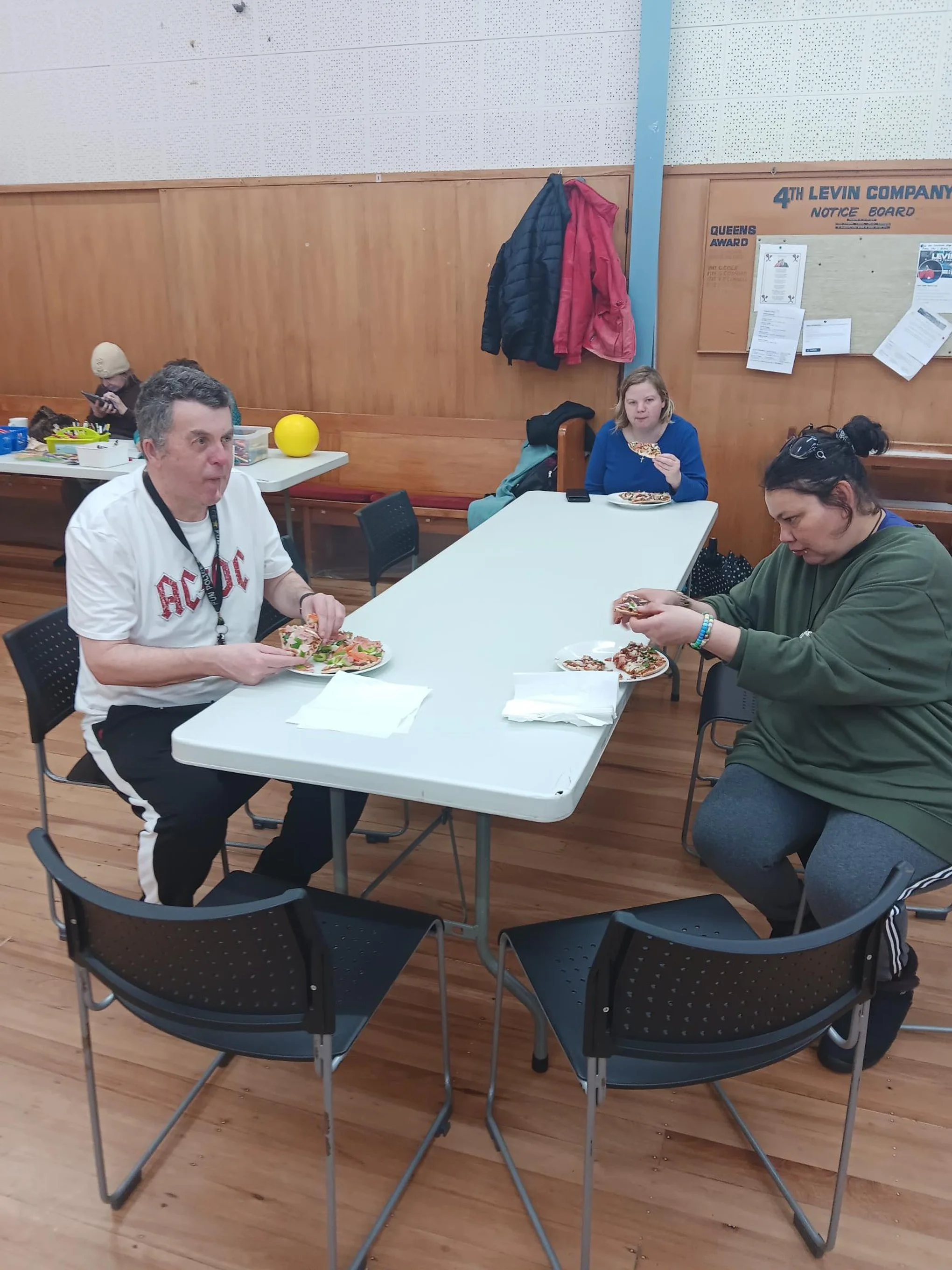Group members eating and chatting at table