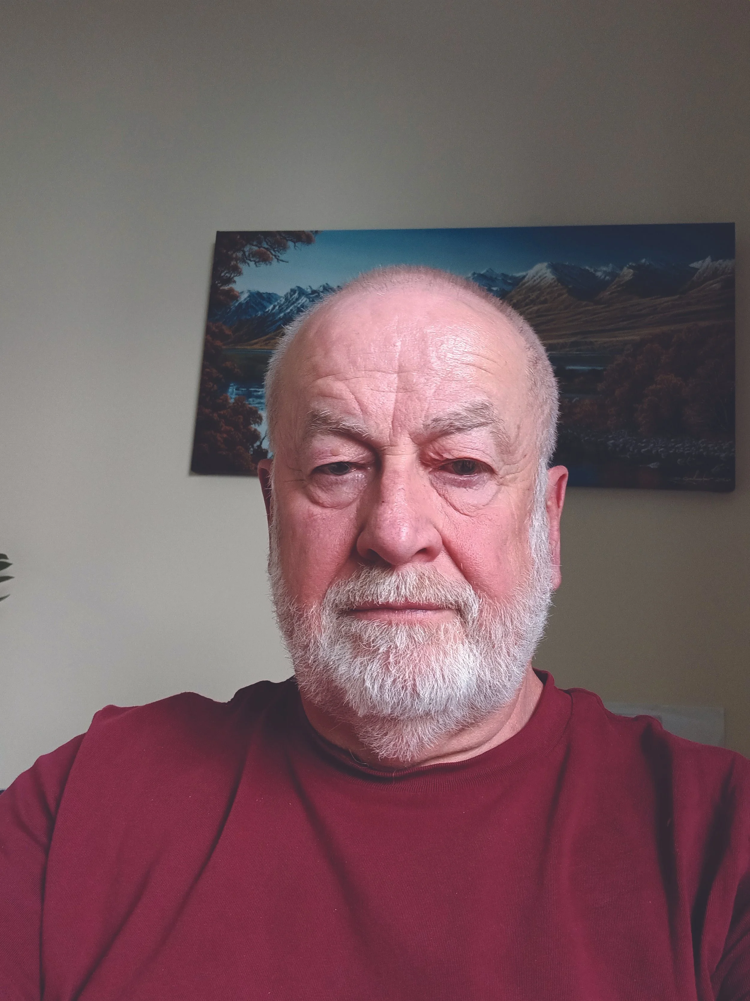 Gary, a man with grey hair and beard wearing a red t-shirt.