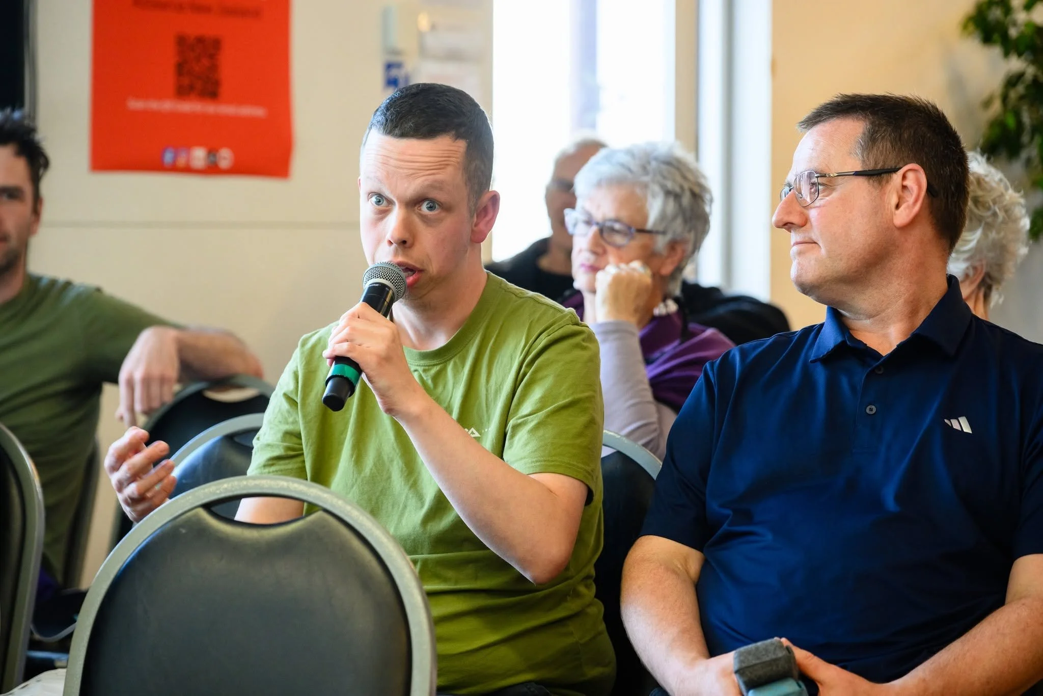 Man in the audience asks a question using a microphone.