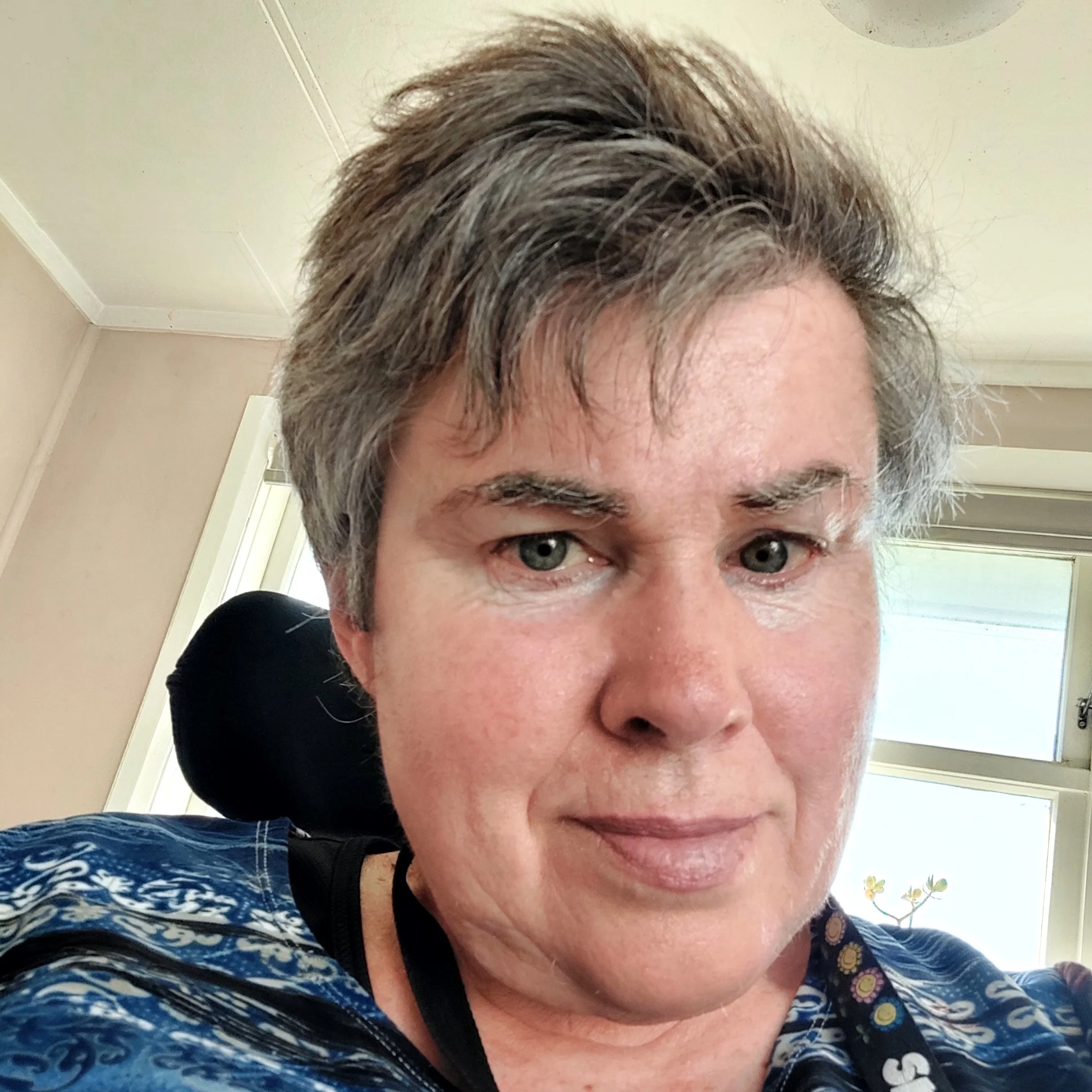 Woman with short grey hair.