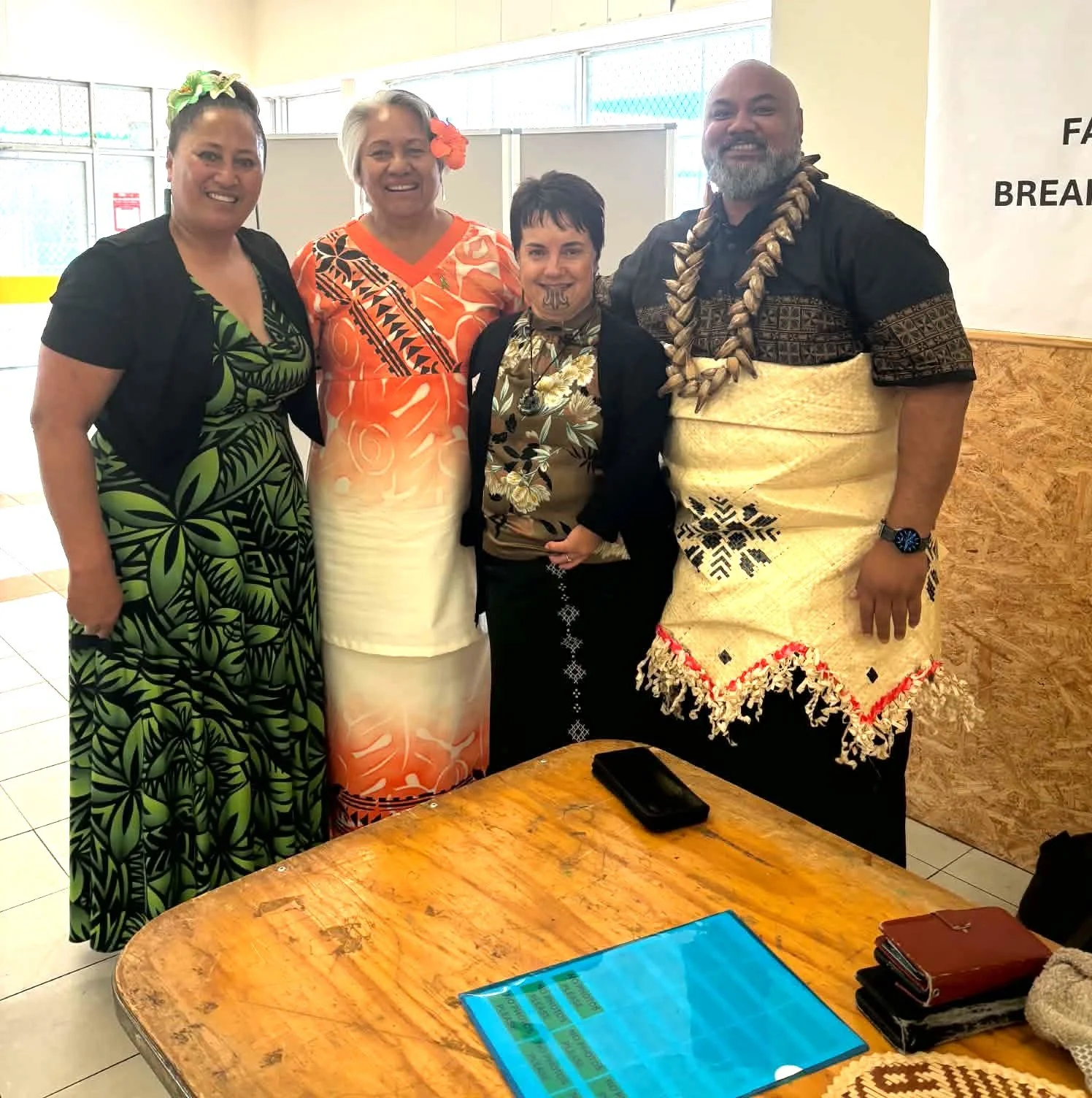 Dairne Kirton standing with MC A'asa and staff members.