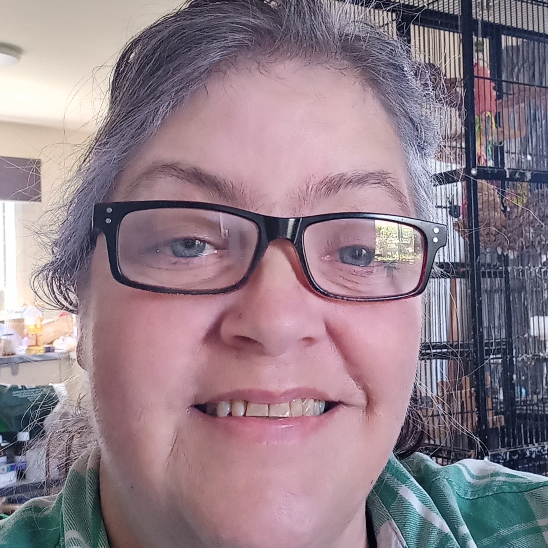 Photo of Nadine Goodall. She is wearig glasses and smiling into the camera.