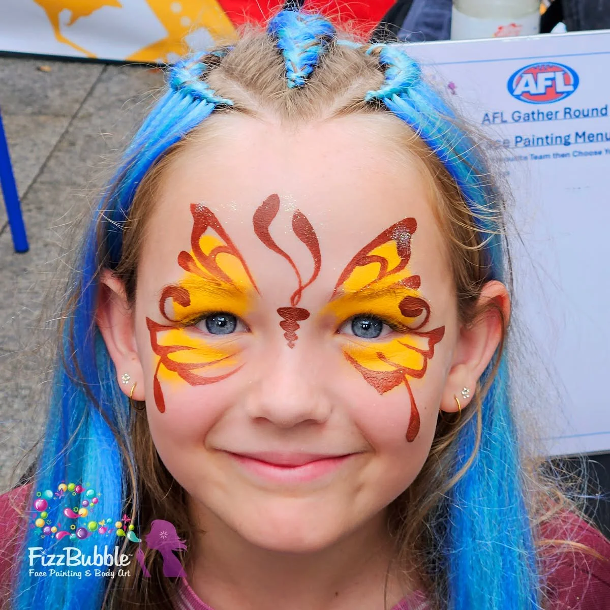 A blue haired, blue eyed Hawks supporter from the Gather Round AFL Ball in the Mall activation today

#fizzbubblefacepainting #afl #gatherround026 #hawthornfootballclub #adelaide
