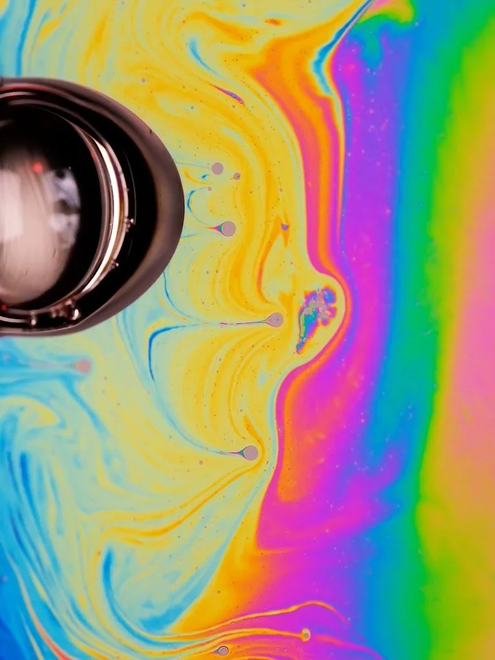 A collection of recordings from my recent experiments with white light reflecting off a flat soap film.

The rainbow-like images were captured with a macro camera at a real-life scale of around 15 mm. What you see is iridescence - an optical effect c