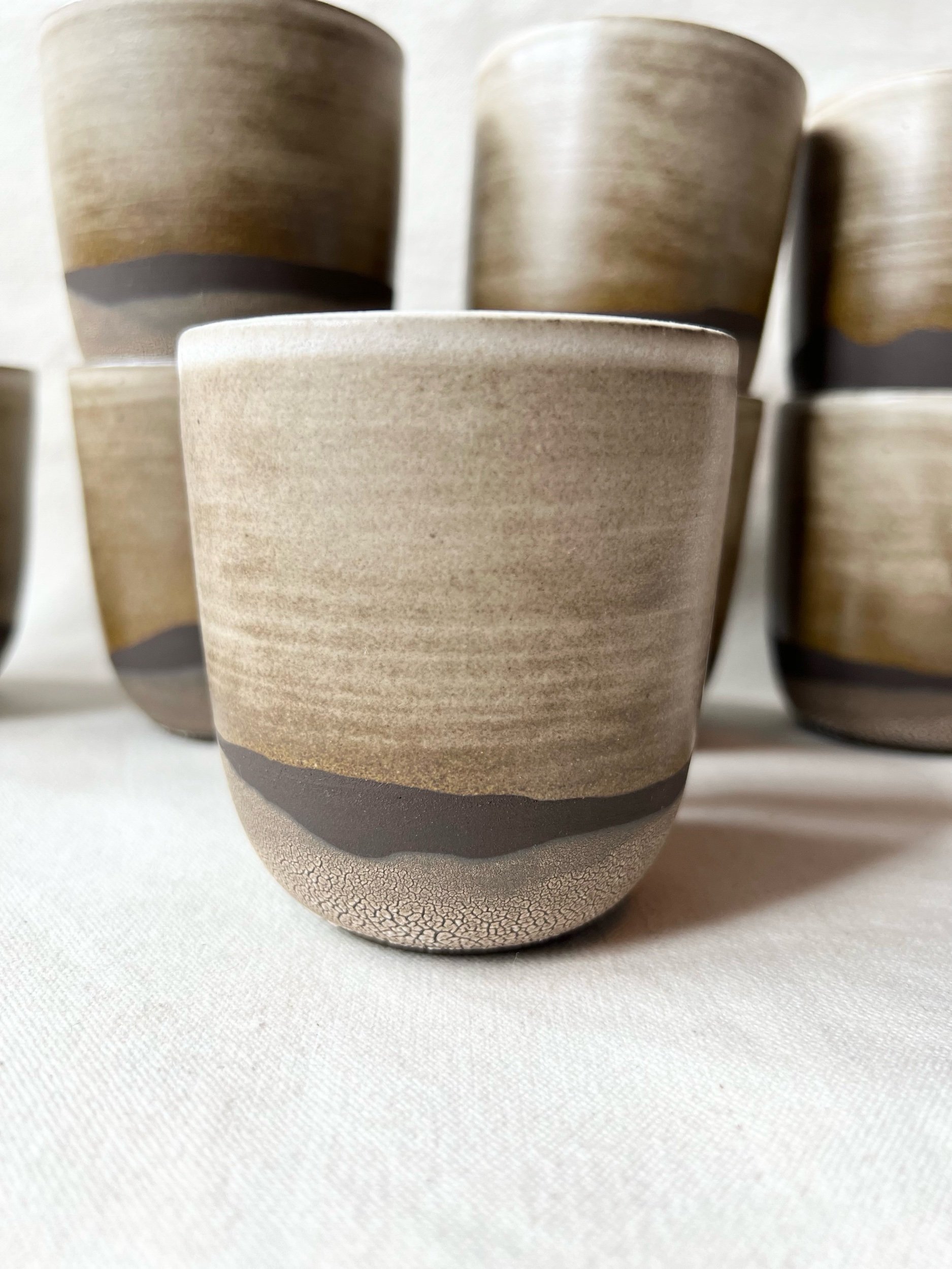 Handmade stoneware tumbler made in Scotland. Modern rustic tableware, inspired by the moody landscapes of the Scottish Highlands in winter. Wheel-thrown pottery, Glasgow, Scotland