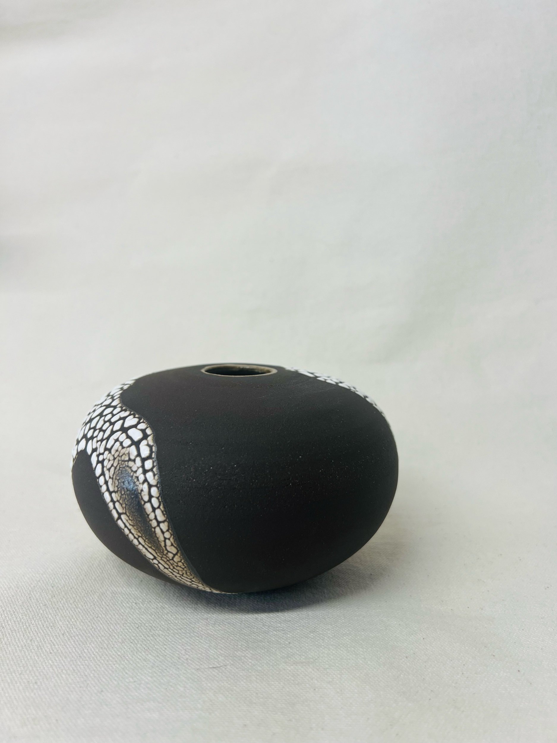Small, handmade ceramic bud vase made with black stoneware. Made in Scotland. Handmade rustic stoneware vase made in Glasgow. Home decor inspired by nature. unique handmade vases. Handmade gifts.