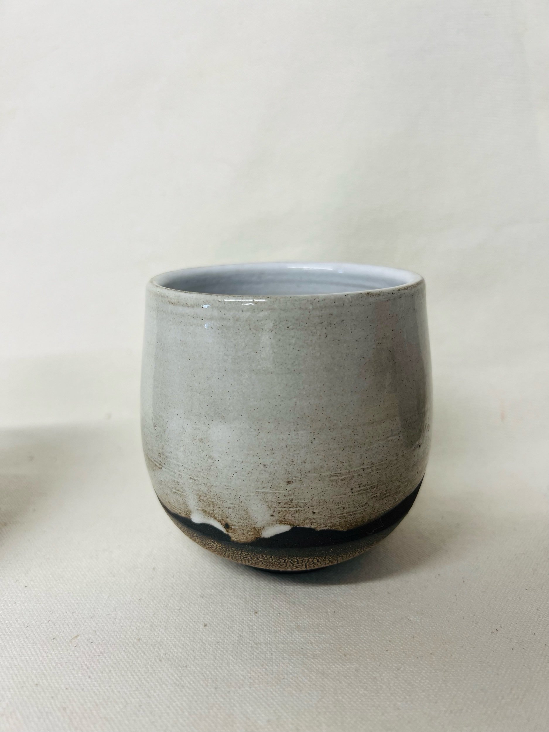 Rustic black stoneware cup made in Scotland. Handmade tumbler made in Glasgow. Modern rustic kitchen. Handmade ceramic tableware.