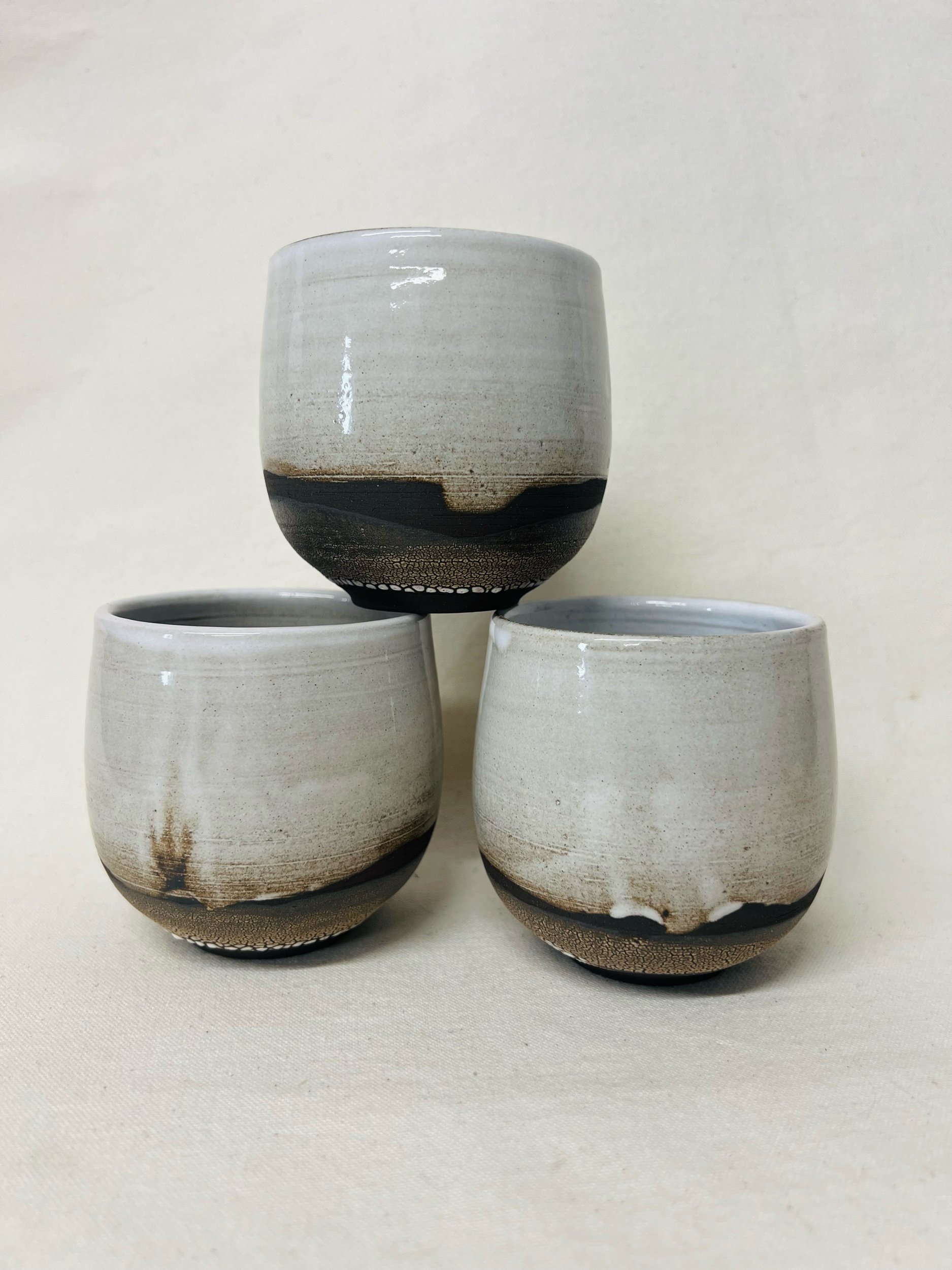 Rustic black stoneware cup made in Scotland. Handmade tumbler made in Glasgow. Modern rustic kitchen. Handmade ceramic tableware.