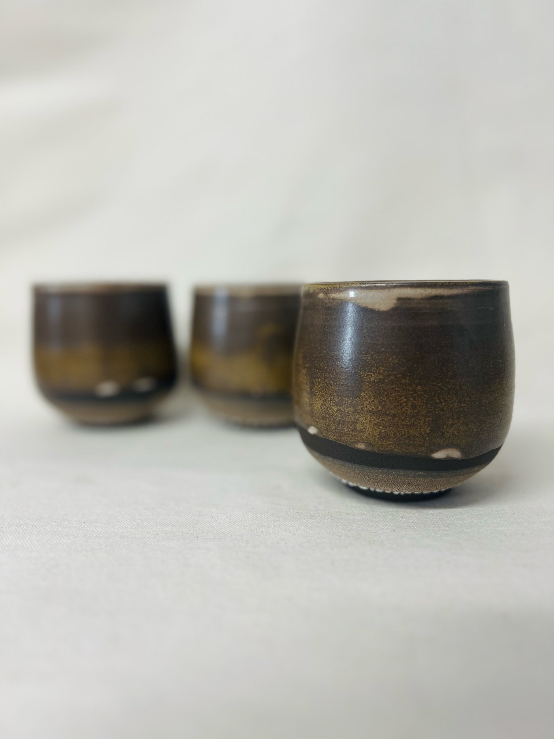 Rustic black stoneware cup made in Scotland. Handmade tumbler made in Glasgow. Modern rustic kitchen. Handmade ceramic tableware.