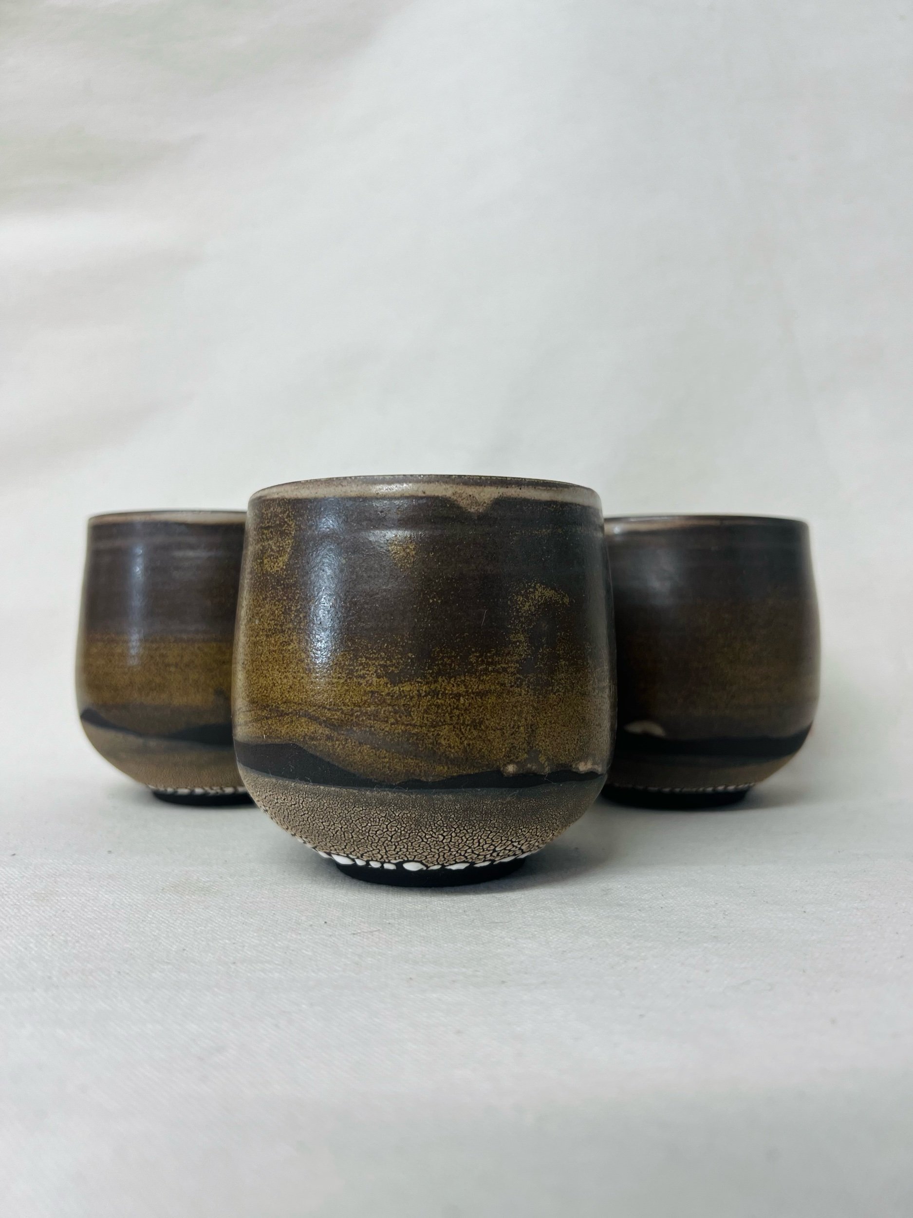Rustic black stoneware cup made in Scotland. Handmade tumbler made in Glasgow. Modern rustic kitchen. Handmade ceramic tableware.