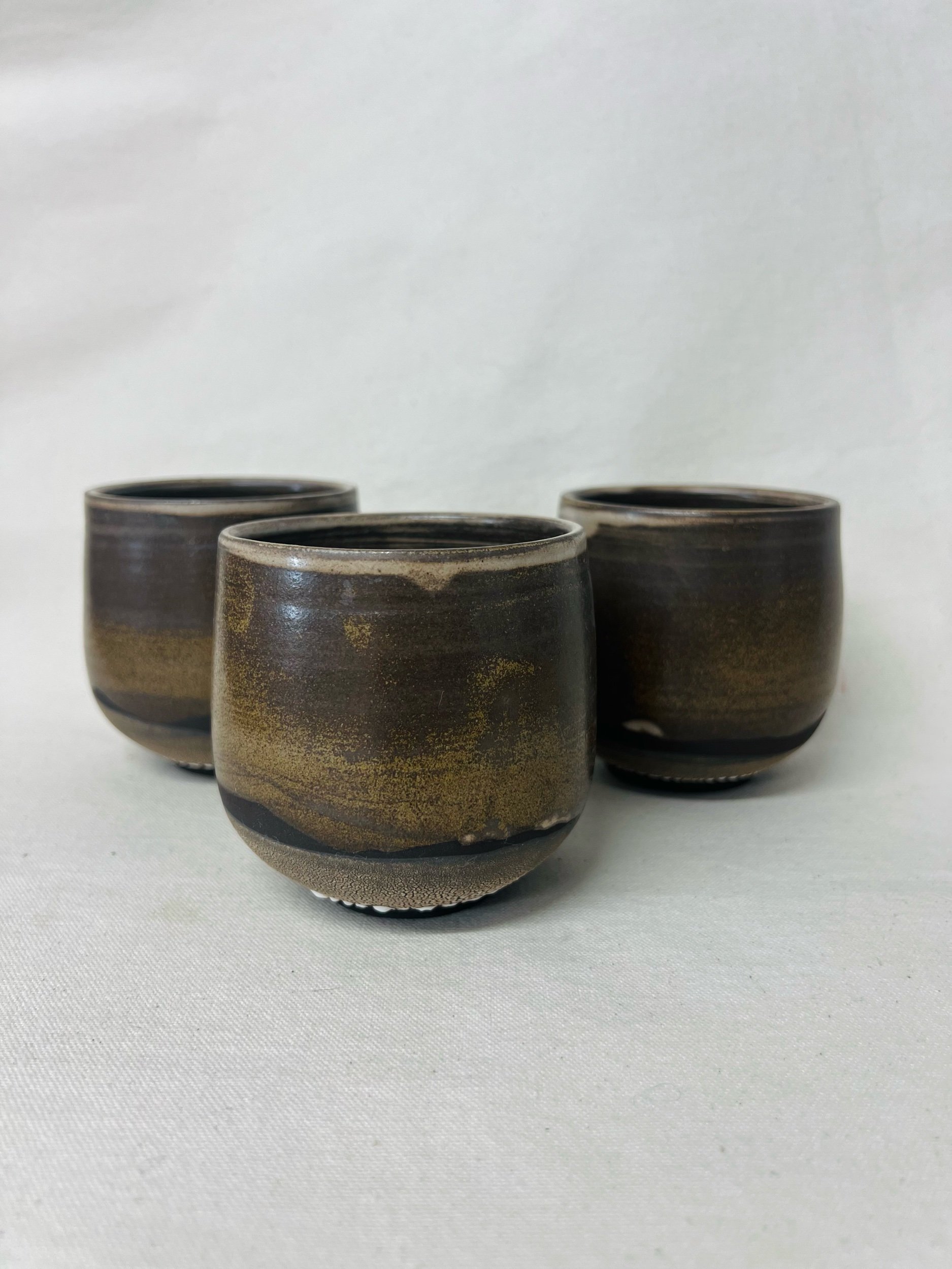Rustic black stoneware cup made in Scotland. Handmade tumbler made in Glasgow. Modern rustic kitchen. Handmade ceramic tableware.