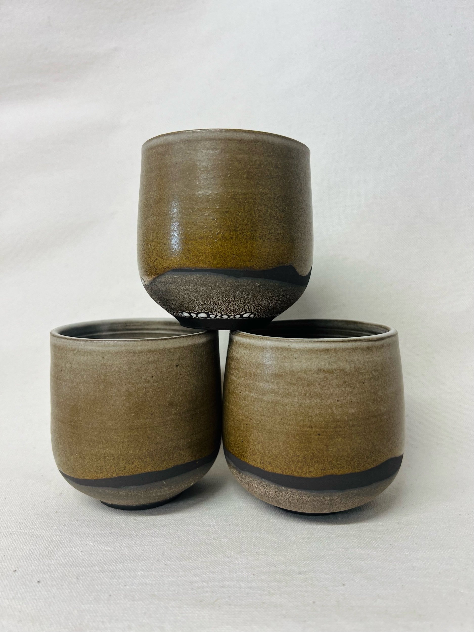 Rustic black stoneware cup made in Scotland. Handmade tumbler made in Glasgow. Modern rustic kitchen. Handmade ceramic tableware.