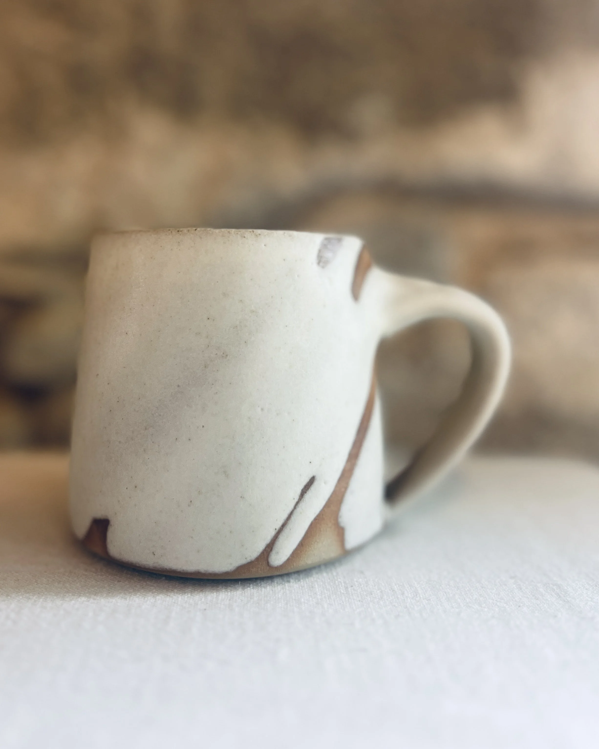 Birch mug handmade by Kim Plimley. Stoneware mug, made in Scotland. Buff stoneware mug with a matte white glaze.