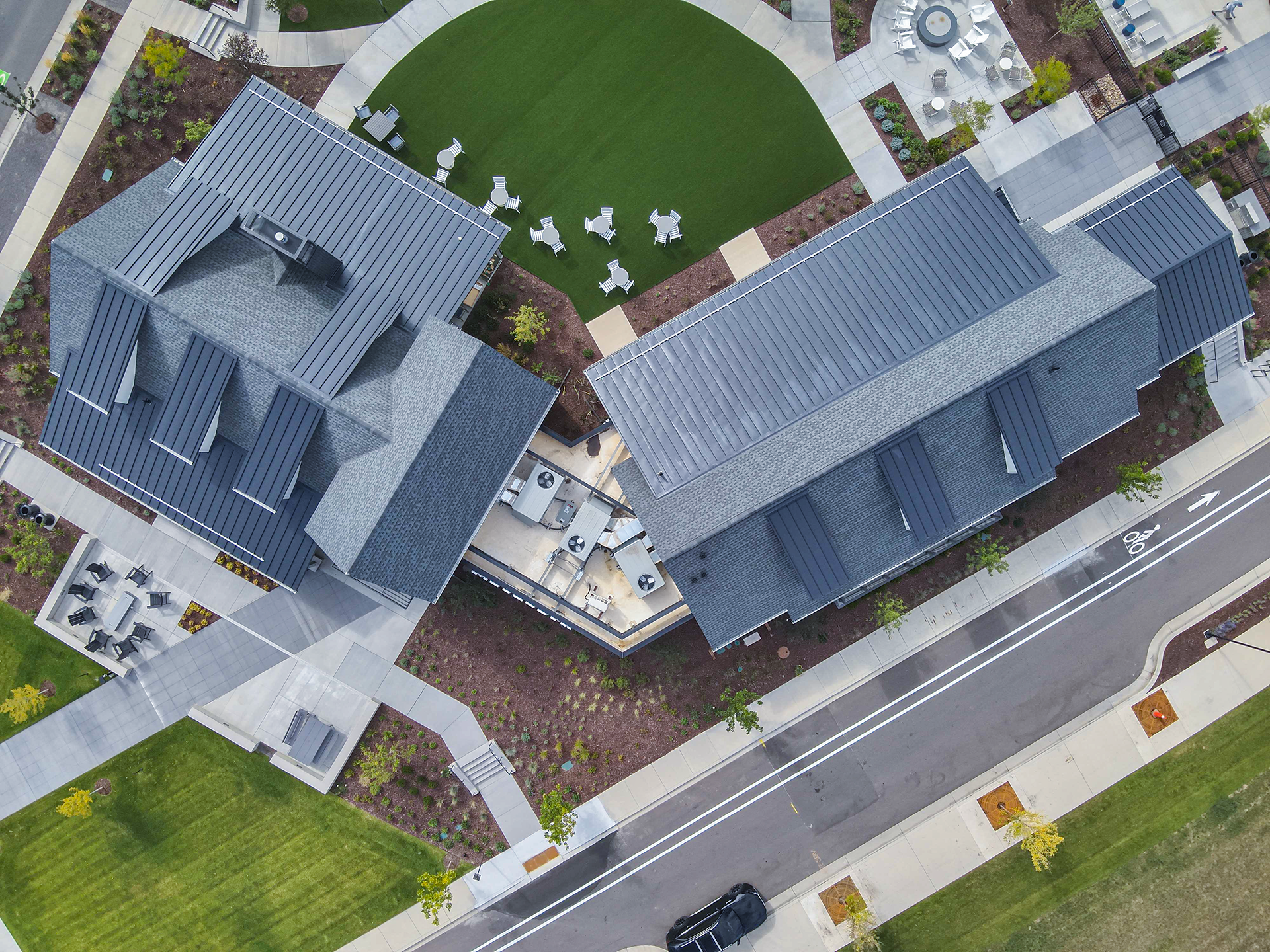 Aerial image of AVI's craftsmanship of interlocking metal panels, shingles and TPO all creating a beautiful roof system.