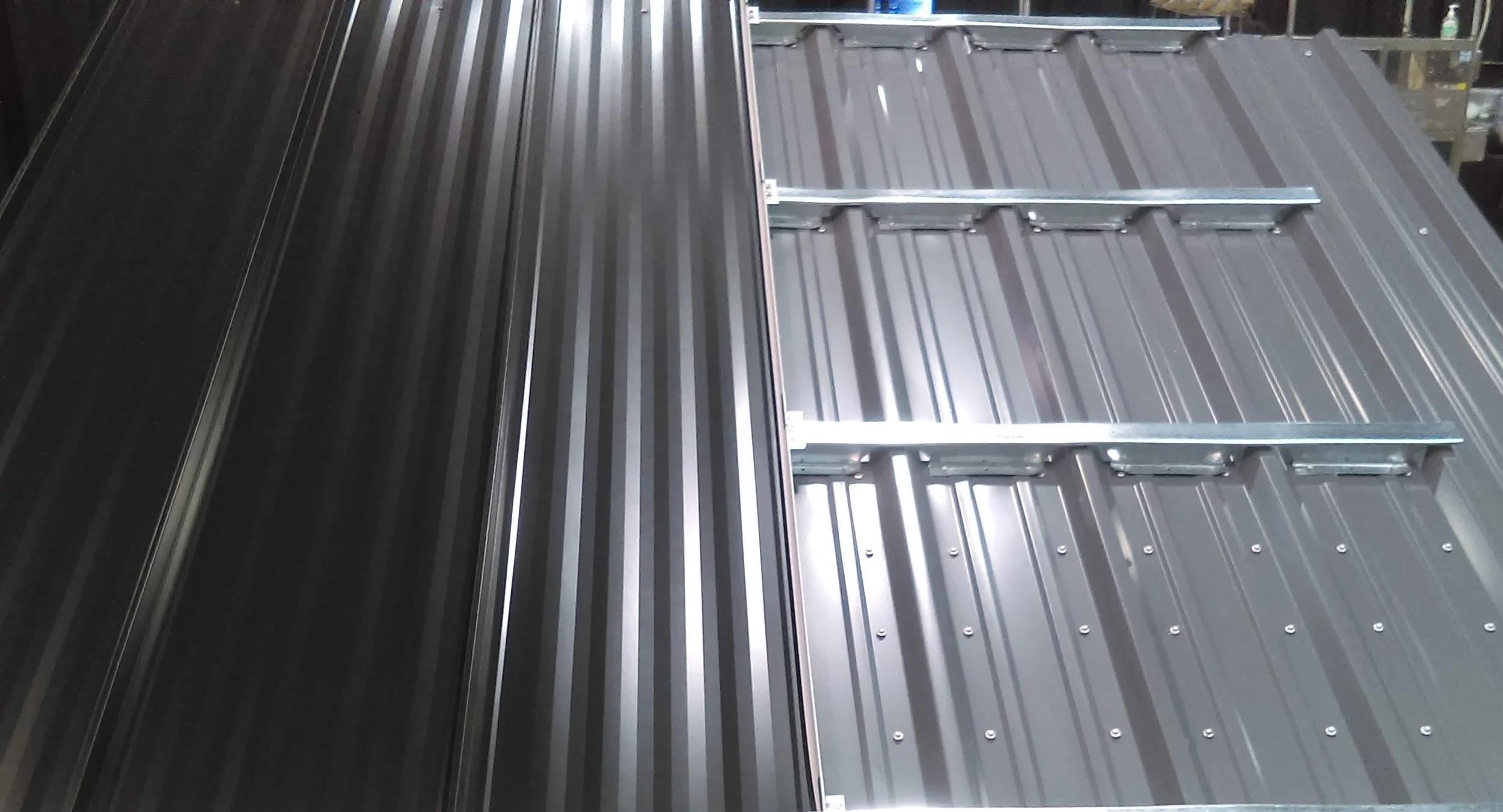 A roof hugger system, a type of metal roofing used on buildings.