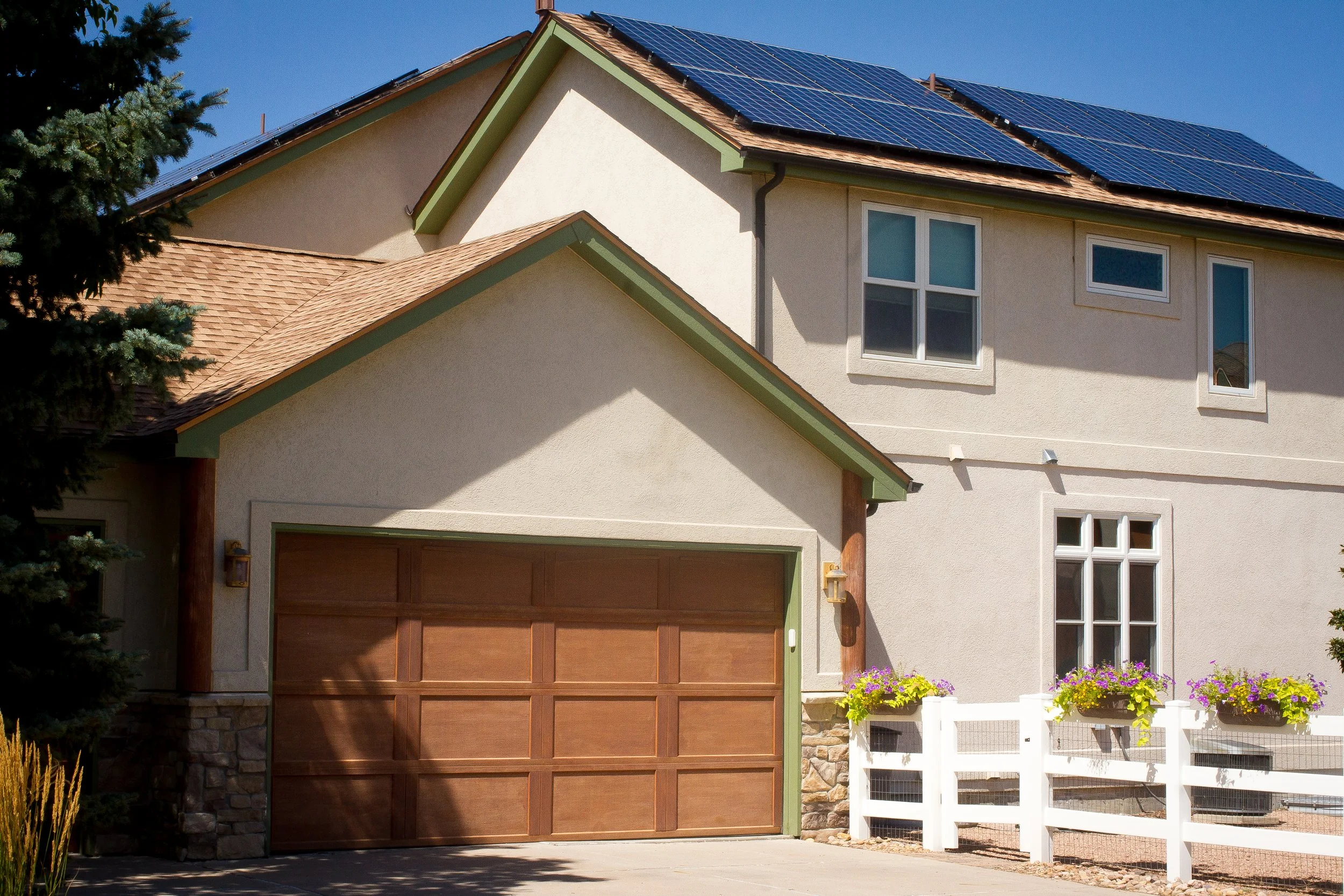 A photo showing a shingle roof on a Colorado home which was installed by AVI Roofing.