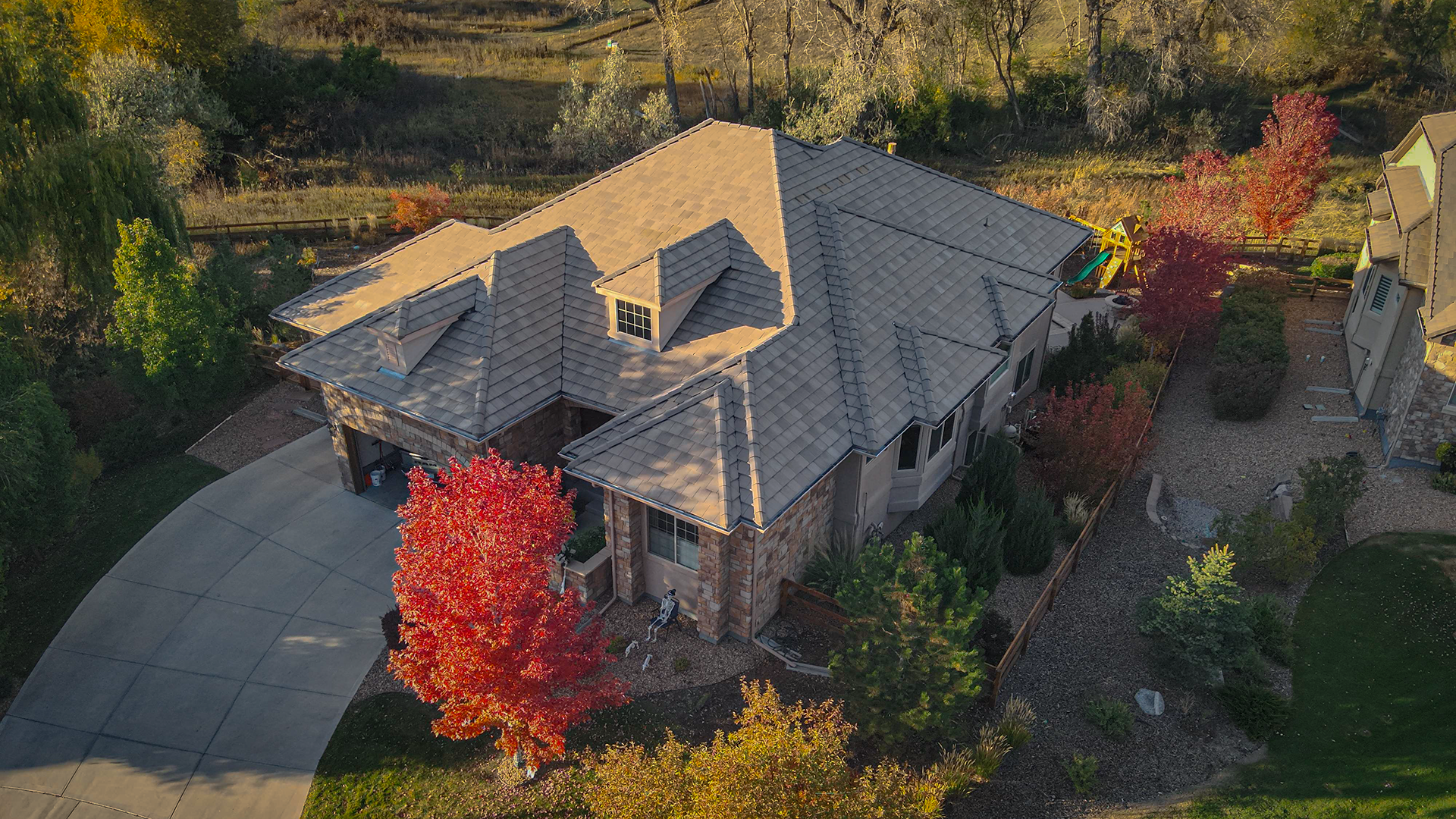 Aerial drone view of a tile roof installed by AVI Roofing.