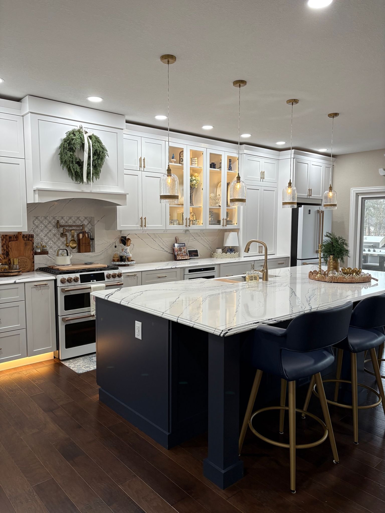 Classic white cabinetry meets modern navy and gold for a fresh, elevated kitchen look.