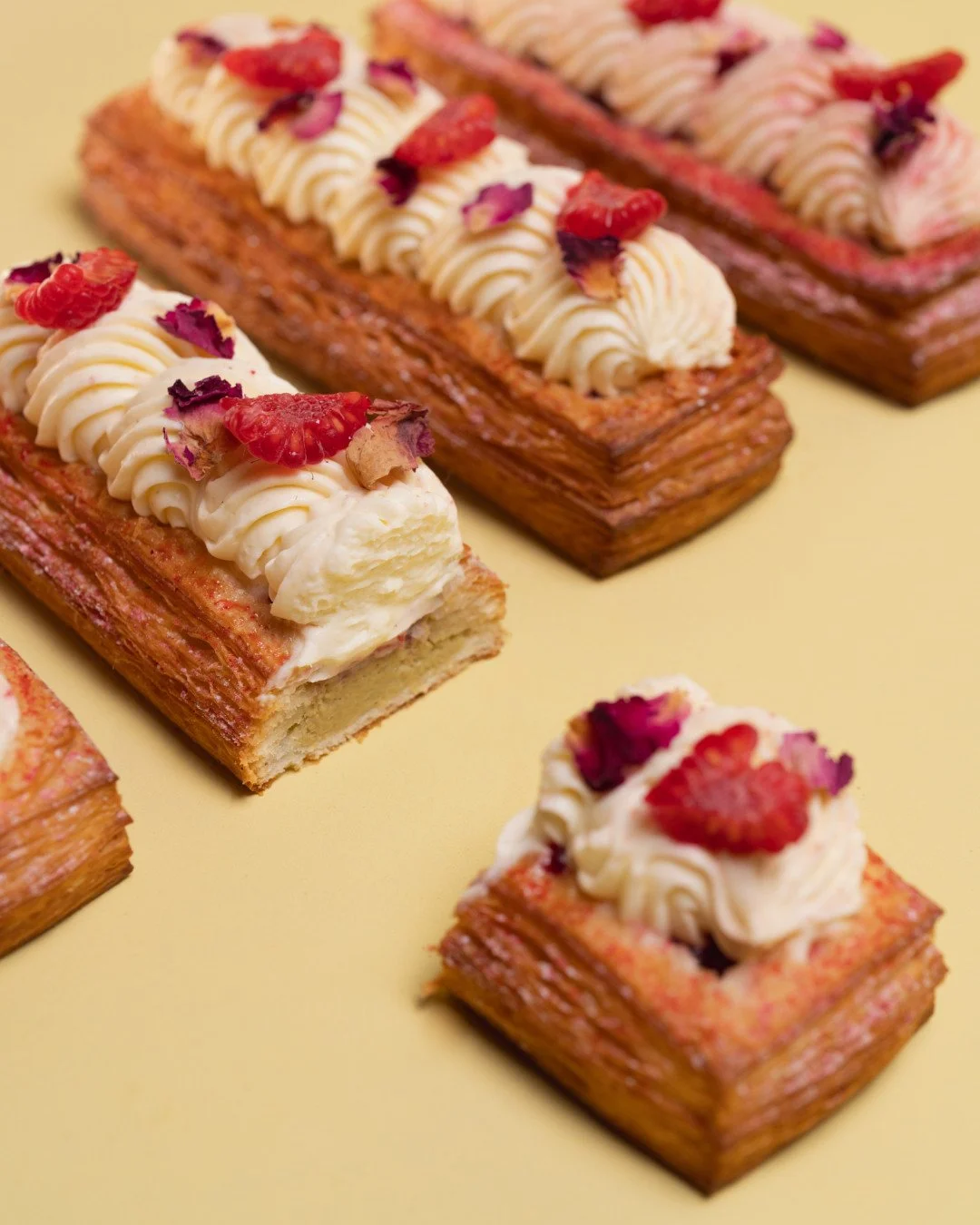 Buttery pastry pistachio cream, raspberry-lychee compote, rose mousse, and fresh berries all in one delicious bar. 🌸⁠
⁠
The Pistachio Croissant Bar is part of our Spring menu, it's light, fruity, and made for sunny days at the Carnival or school hol