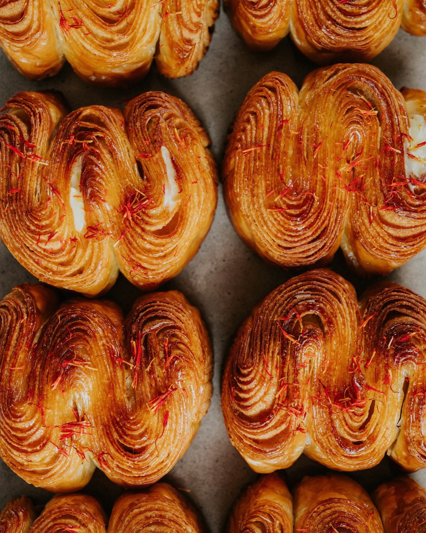 Flaky croissant layers shaped into a wave, filled with fragrant orange + cardamom cream, then finished with a light glaze of orange blossom syrup. It&rsquo;s quickly becoming a fav of the new autumn menu! 🍁

Duck in and try it yourself ✨

#thebakers