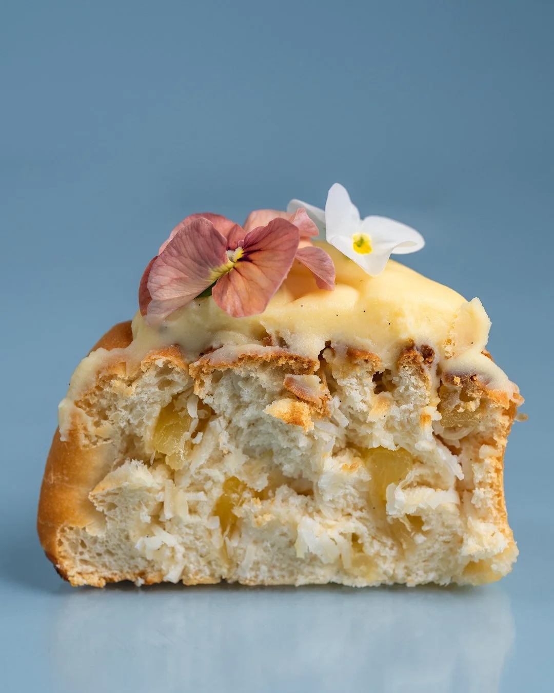 Our pi&ntilde;a colada scroll is basically a beach holiday in pastry form. 🍍🏖️⁠
⁠
Shredded coconut, pineapple compote, all rolled through a soft, buttery scroll and finished with a vanilla glaze.⁠
⁠
#thebakersduck⁠
⁠
#ae #mf