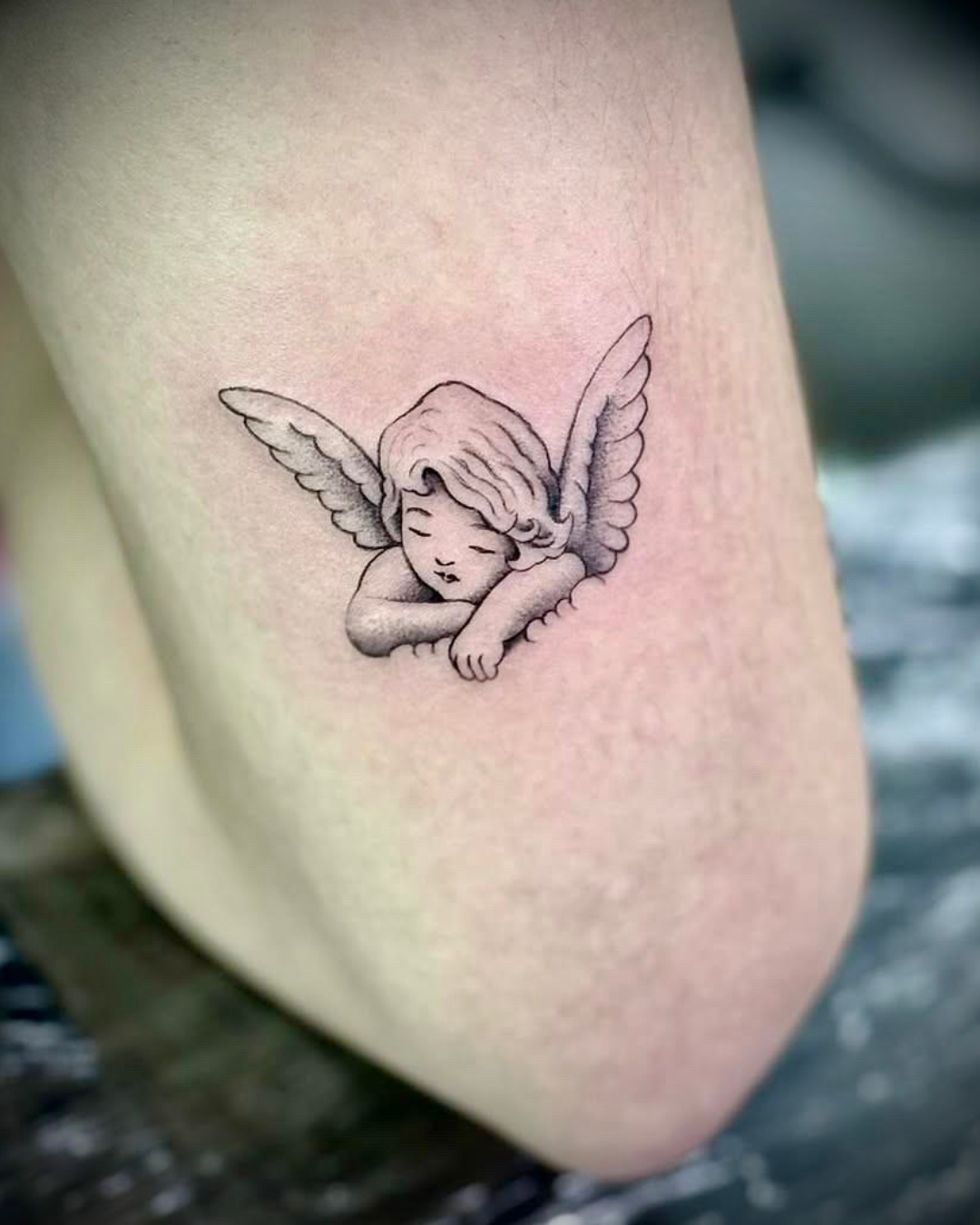 fine line cherub tattoo