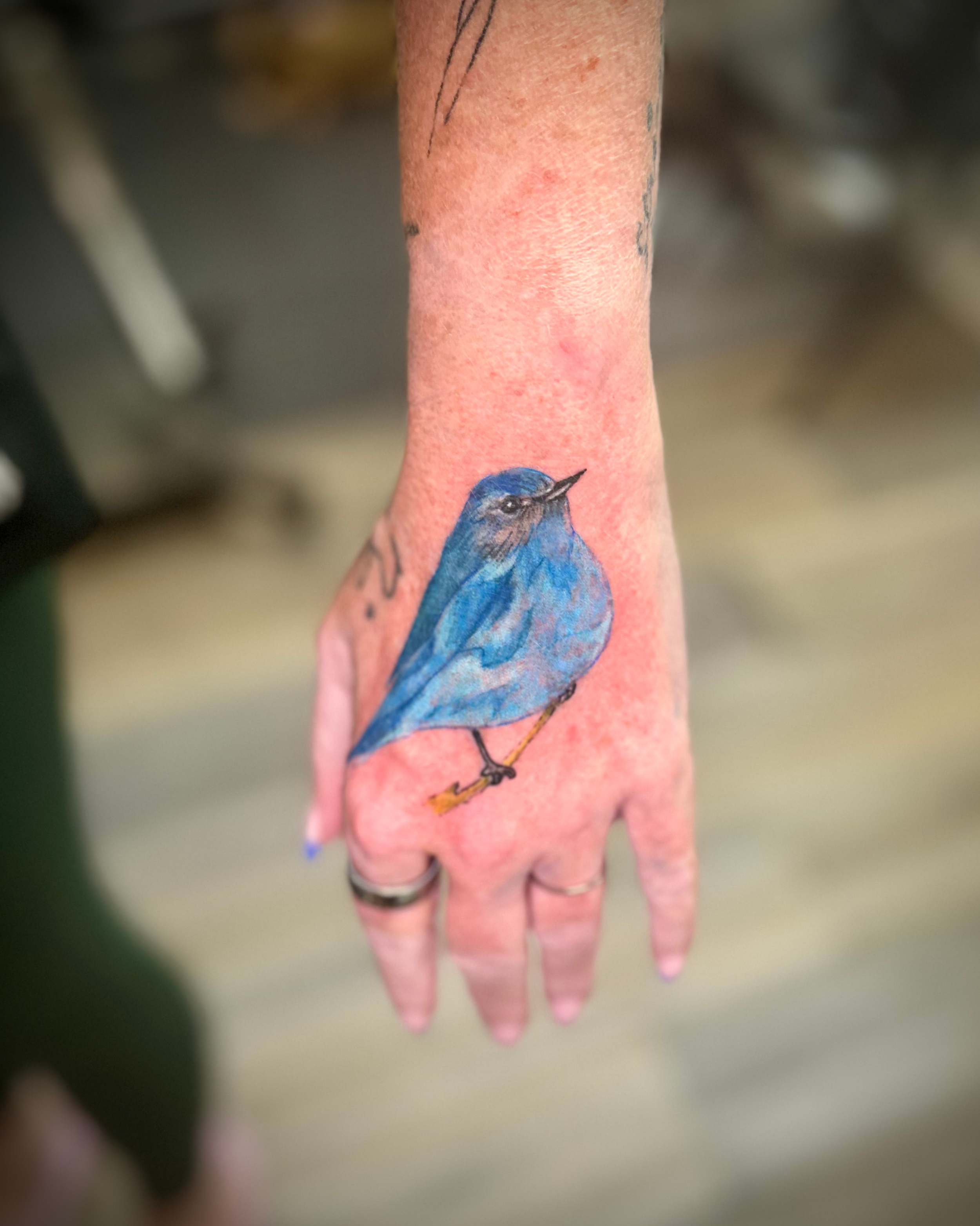 blue bird hand tattoo