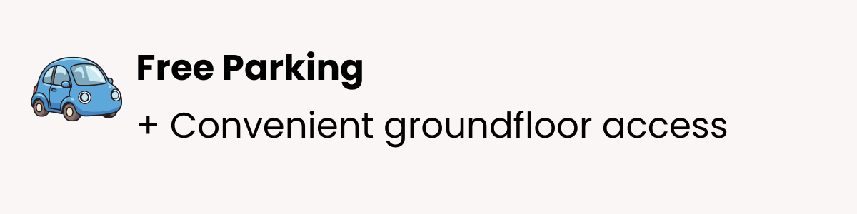 Sign advertising free parking with a blue cartoon car icon and text 'Free Parking + Convenient groundfloor access'.