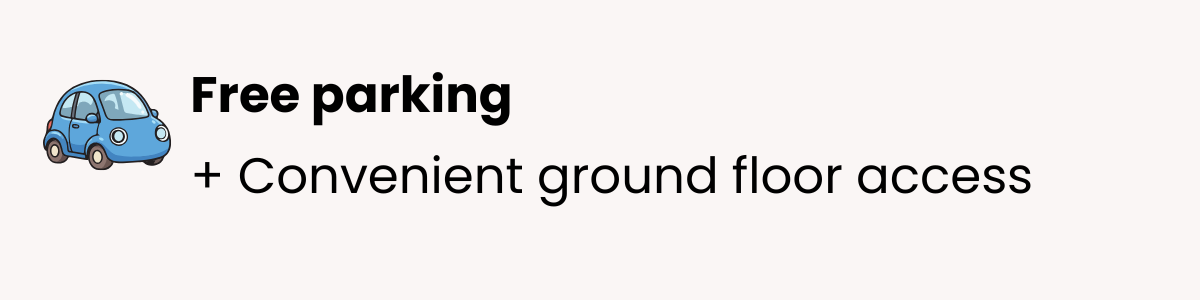 Sign with a blue cartoon car icon, the words "Free parking" in bold, and additional text "+ Convenient ground floor access".