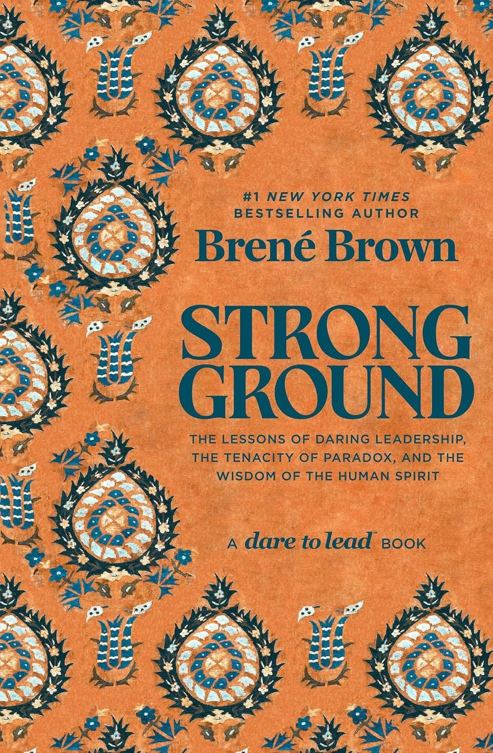 Cover of the book 'Strong Ground' by Brené Brown, with a patterned orange background and black, blue, and white decorative motifs.