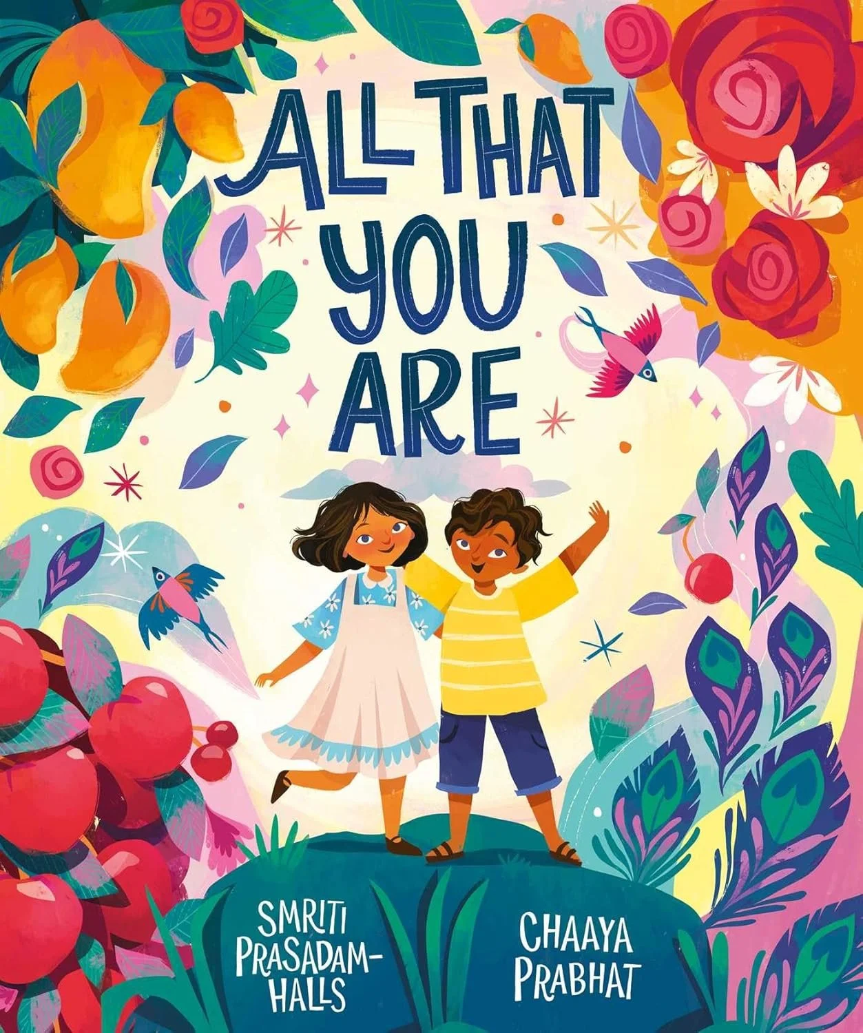 A colorful illustration featuring two children, a girl and a boy, standing on a green patch with the title 'All That You Are' at the top. The background is filled with flowers, leaves, and birds, with the authors' names, Smriti Prasadam-Halls and Cha