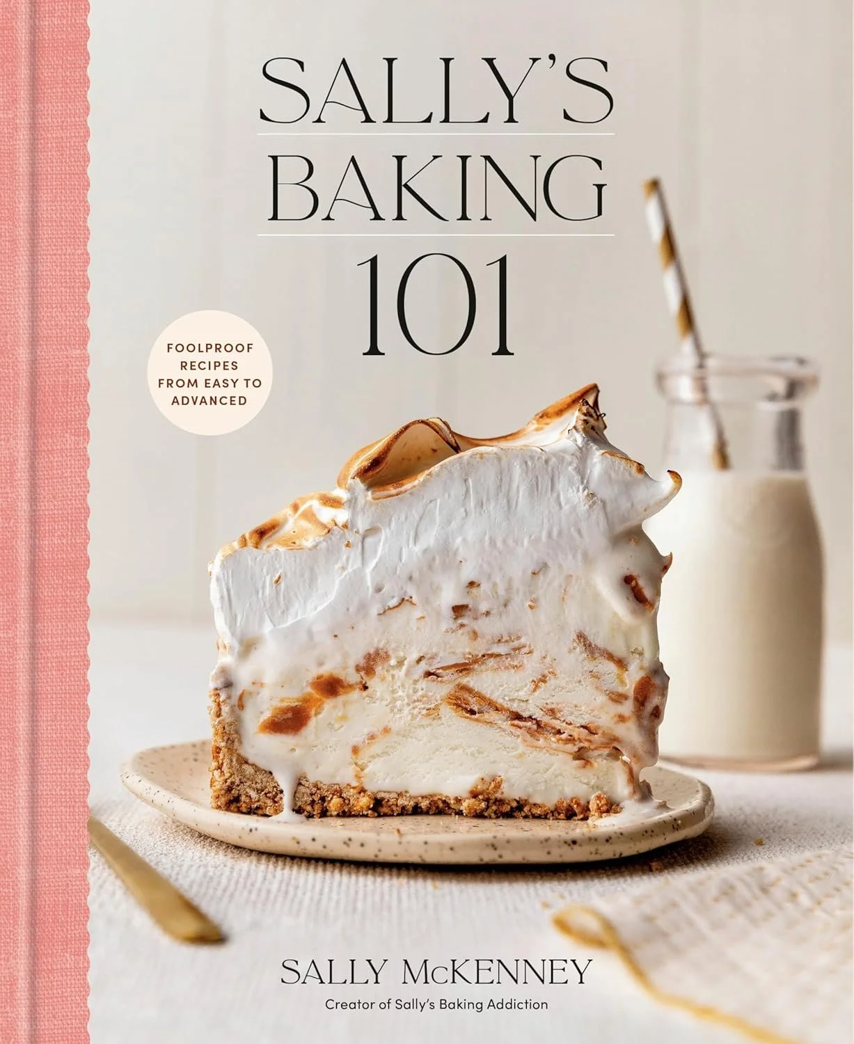 Book cover titled 'Sally's Baking 101' featuring a slice of cream pie with a graham cracker crust and toasted meringue topping, with a milk bottle and striped straw in the background.