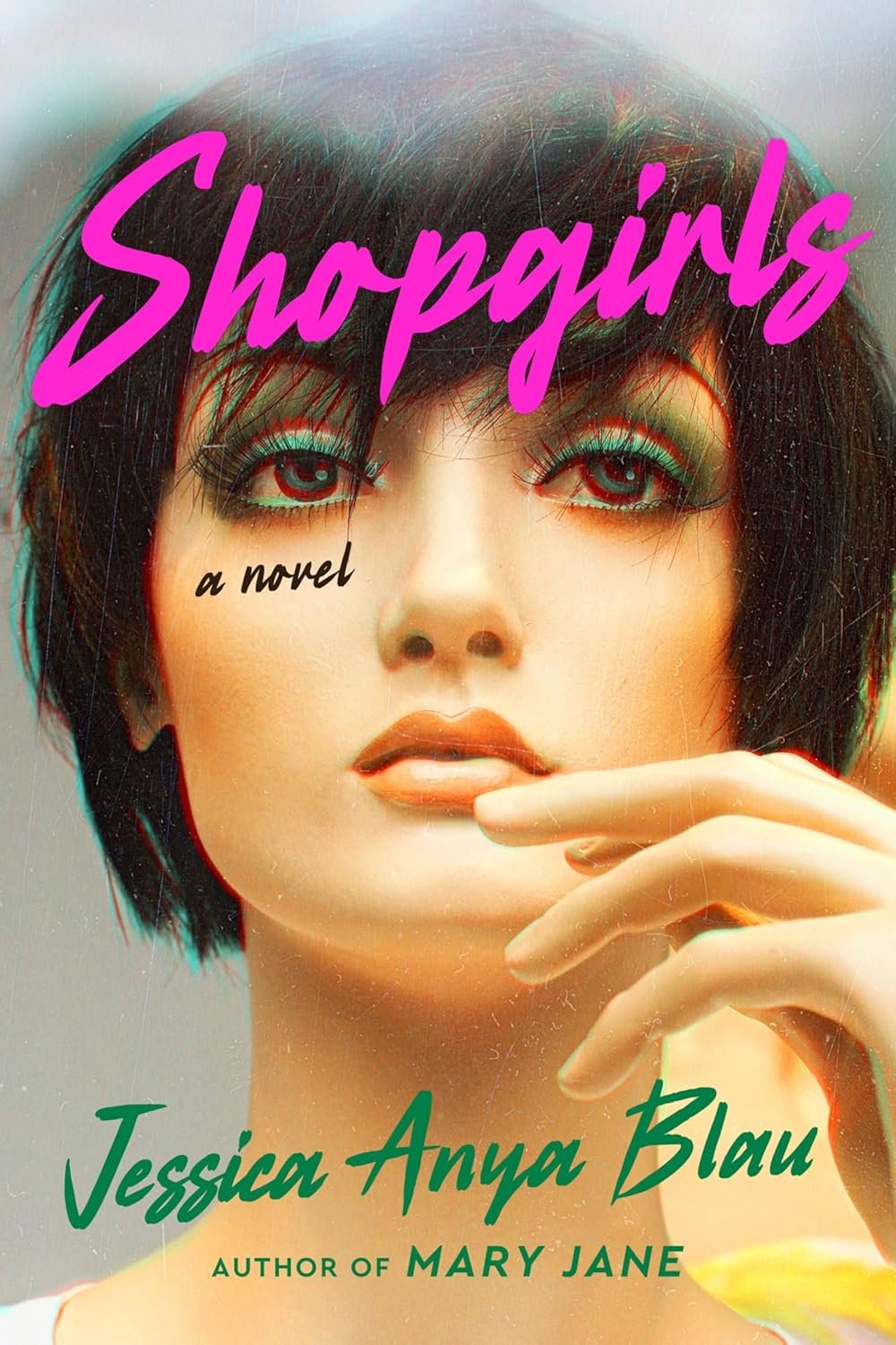 Cover of the novel "Shopgirls" by Jessica Anya Blau, featuring a stylized portrait of a mannequin with short dark hair, bright eye makeup, and a finger near the lips. The title is in bold pink font.