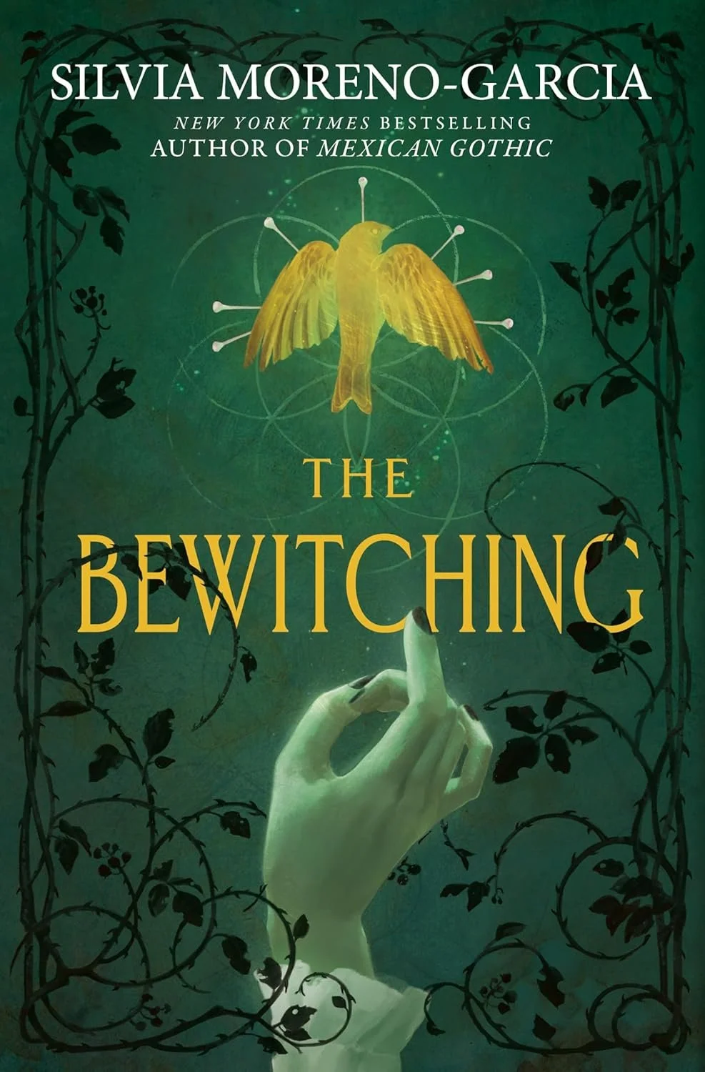Book cover for 'The Bewitching' by Silvia Moreno-Garcia featuring a green background with black vine designs, a pale hand with a raised finger, and a yellow bird with pin-like pins around it.
