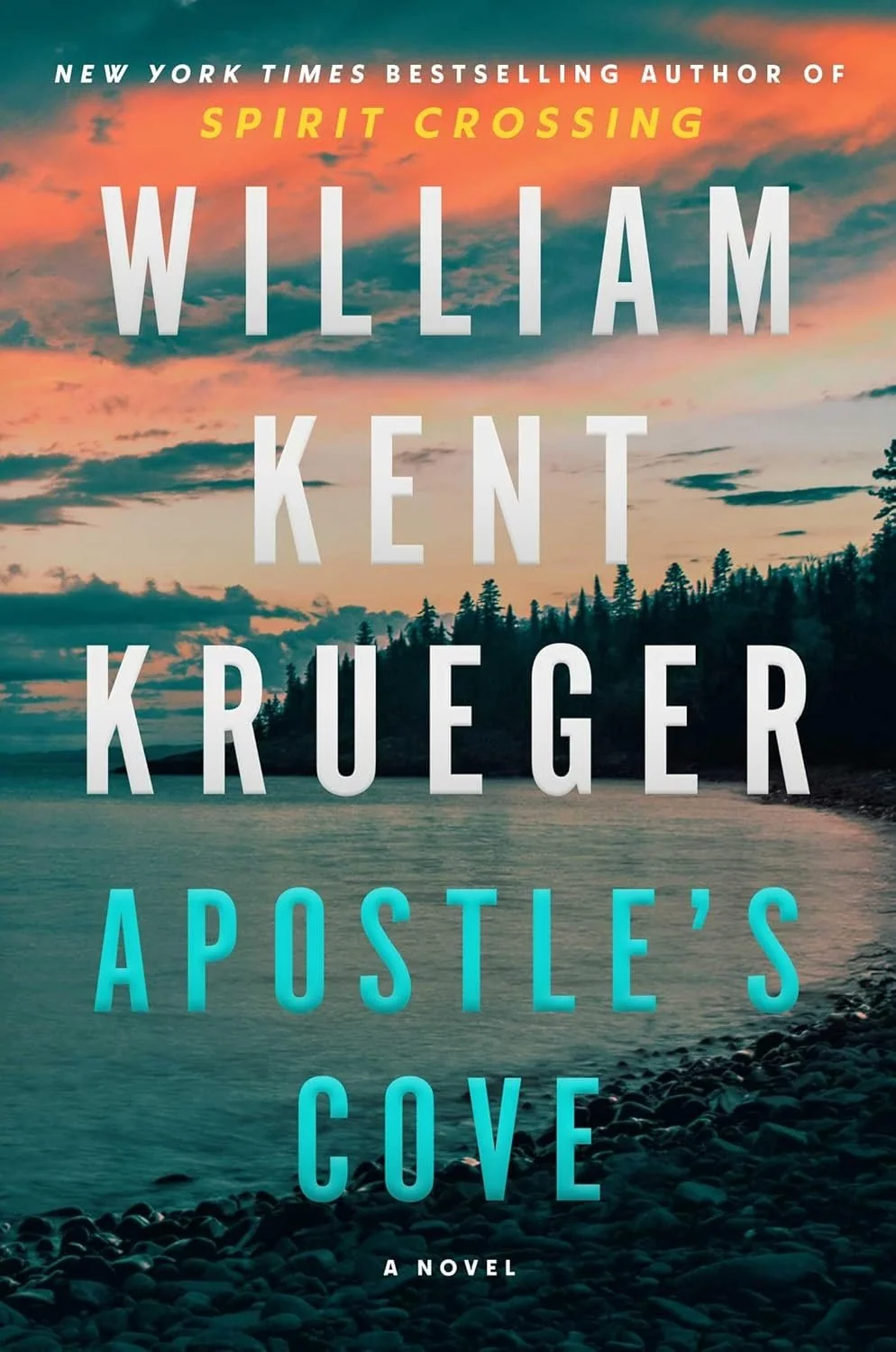 Book cover for 'Apostle's Cove' by William Kent Krueger, featuring a scenic lakeside view at sunset with a rocky shoreline, calm water, and forested hills under a colorful sky.