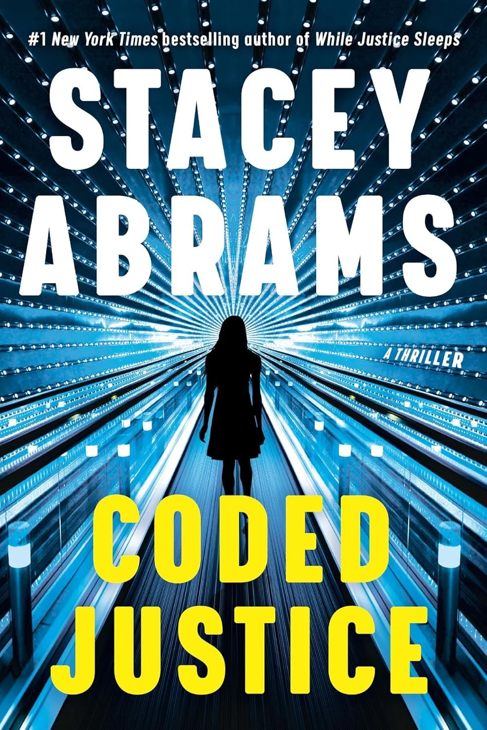 Cover of the book titled 'Coded Justice' by Stacey Abrams, depicting a silhouette of a woman walking through a tunnel of bright blue and white lights, with the author's name in large white letters and the title in yellow letters.