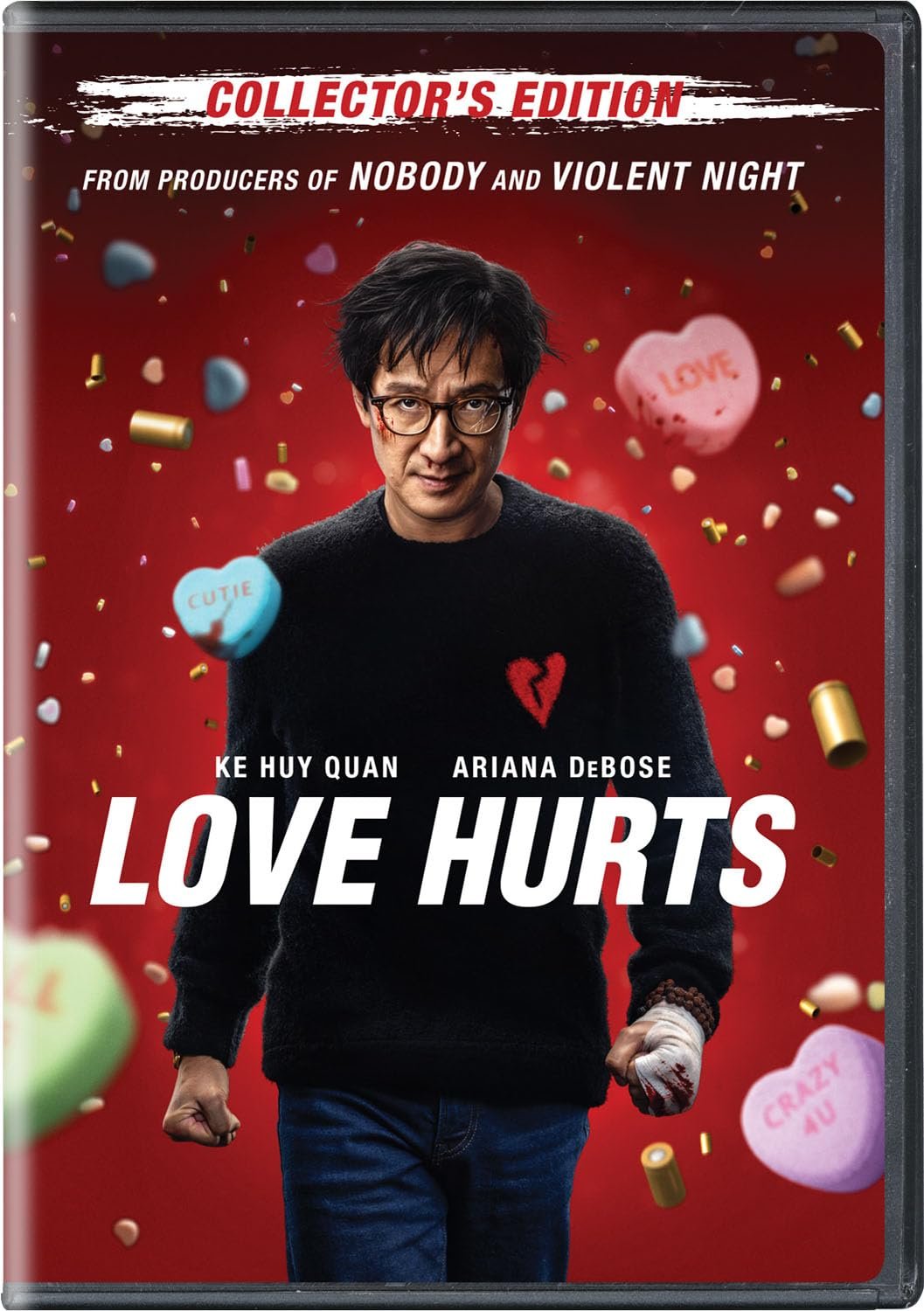 Movie cover for 'Love Hurts' featuring a man in glasses with a black sweater displaying a broken heart design, set against a red background with candy hearts and bullet casings. Text includes 'Collector's Edition,' 'From producers of Nobody and Viole