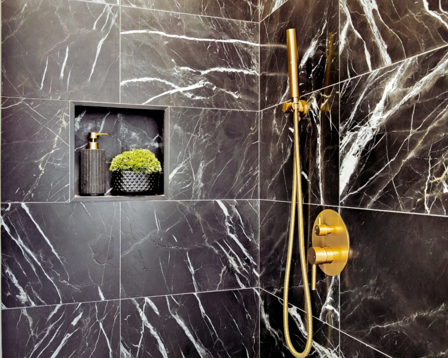 Bold black tile on shower walls