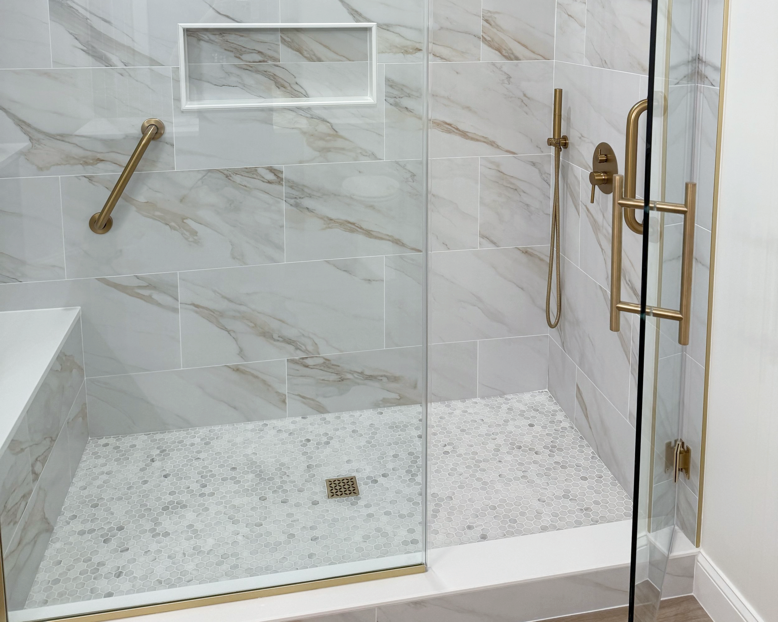 Walk-in shower in a small bathroom remodel with frameless glass and custom tile