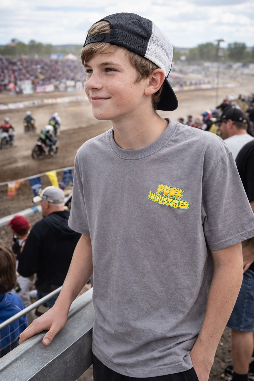 Teen boy in brown punk industries shirt.png