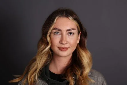 A headshot image of Jane Hamlin wearing a grey tshirt
