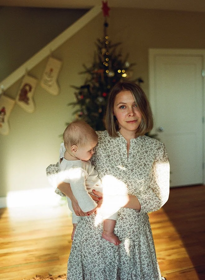 a filmy, grainy, warm cinematic film pictures of a mom holding her baby girl taken by Asheville's number one family photographer, Melina Coogan