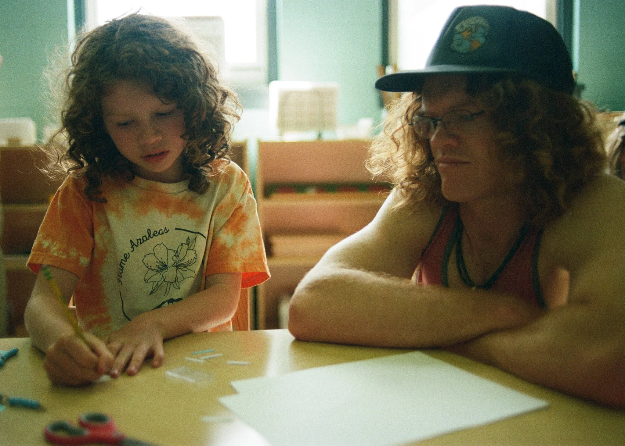 A father smiles at his daughter during a public school open house in Asheville.