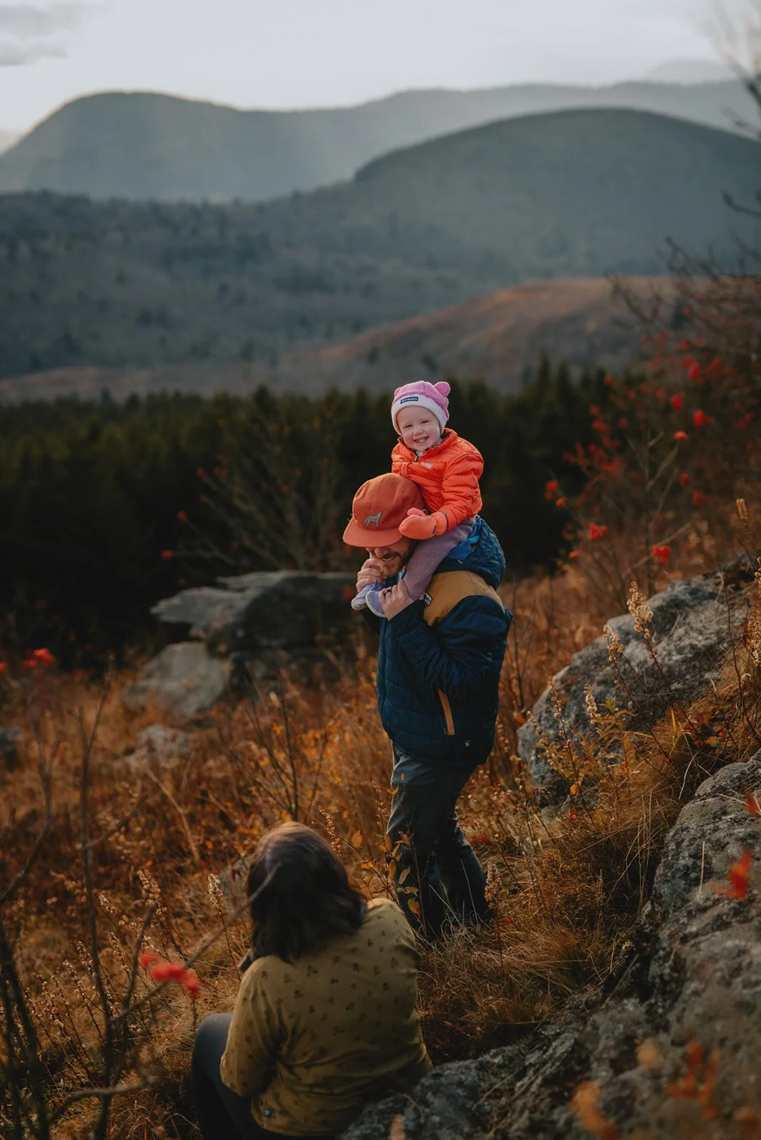A family of three so happy to be in the mountains getting their photos made by Melina Coogan who is Asheville's best family photographer