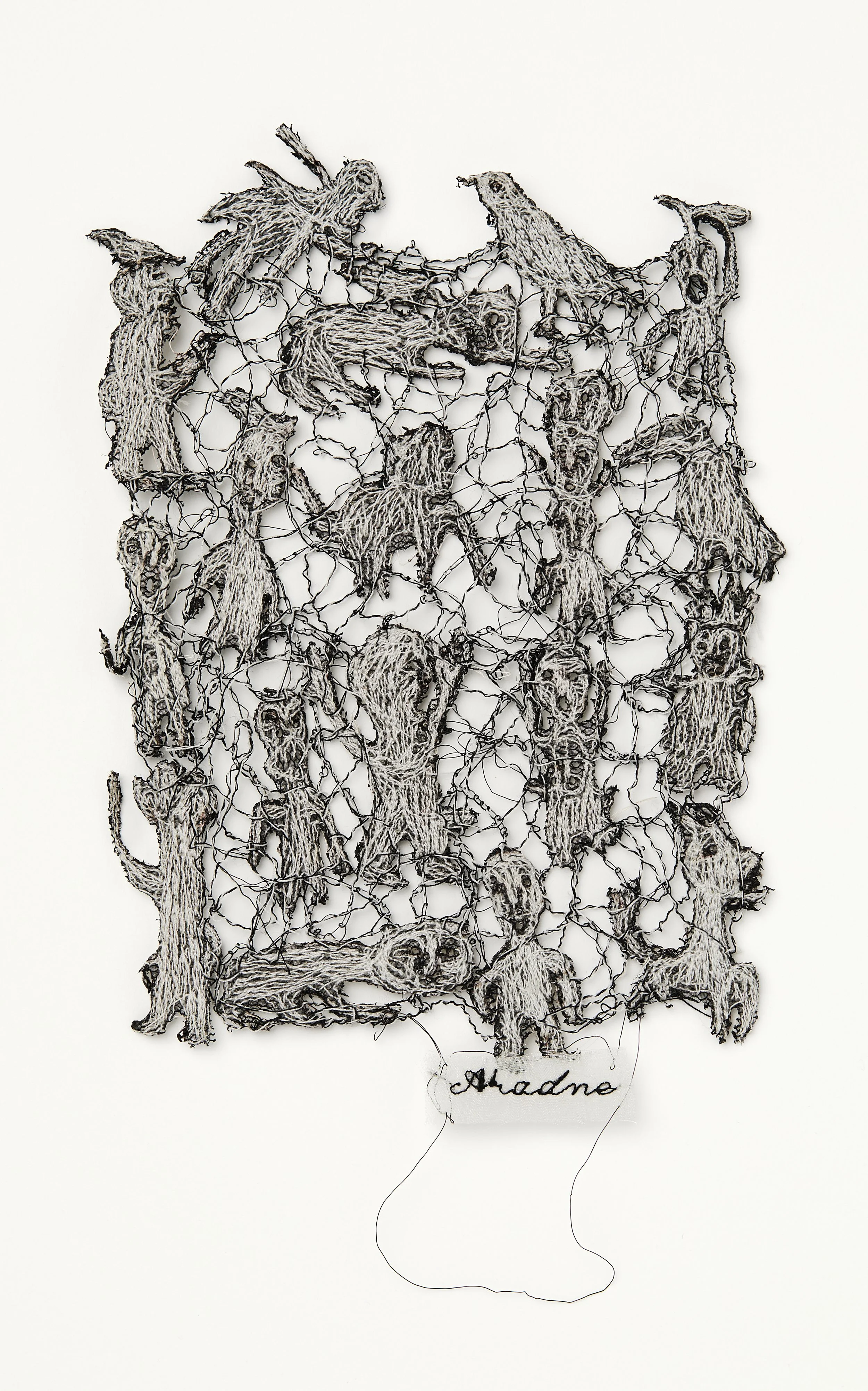 Black & white lace like piece with figures with scared faces. Intermingled with animals & birds. Figures appear in 4 vertical rows, topped with 2 birds & joined by black/white threads.