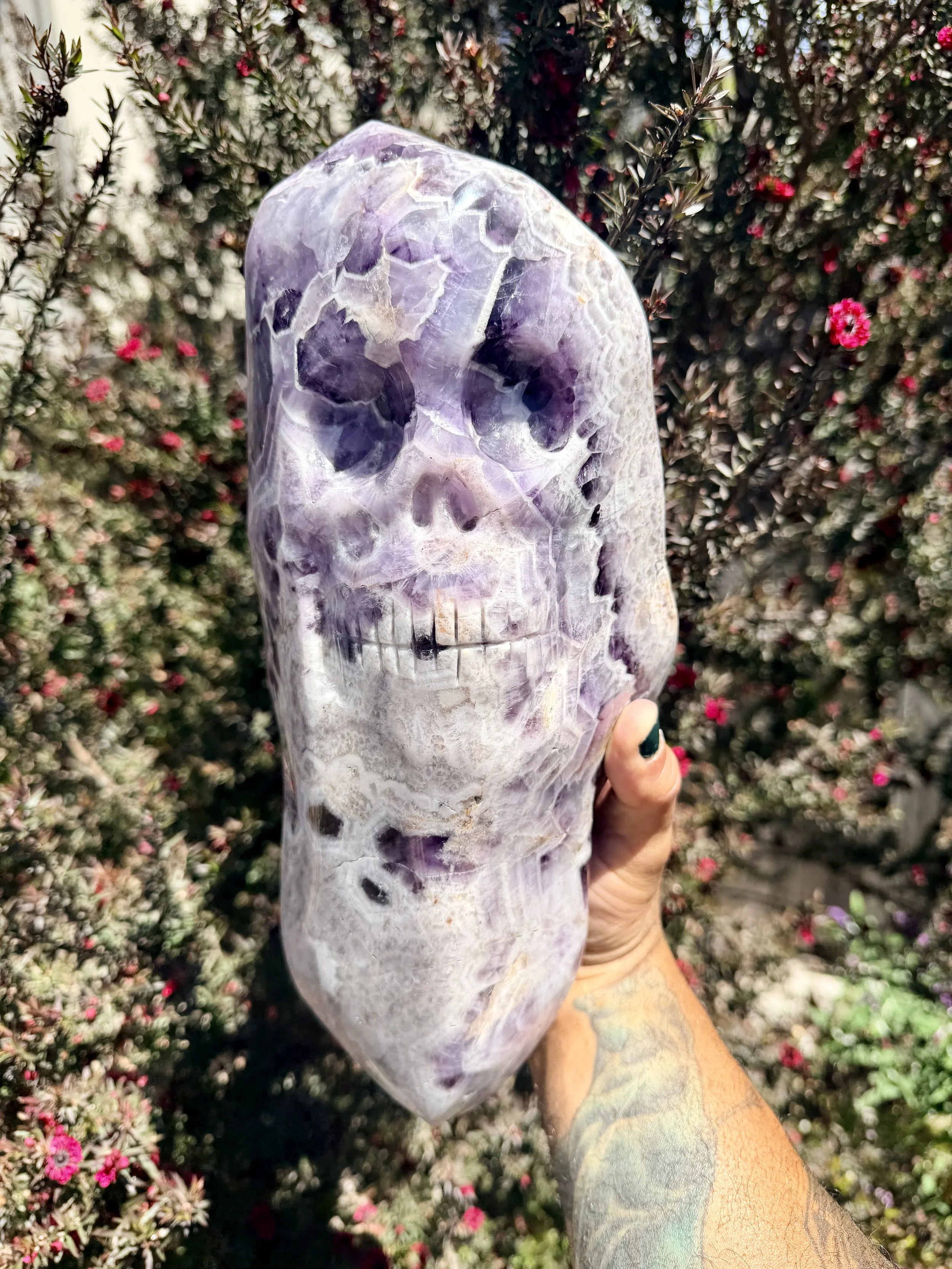 Material: Chevron (Dream) Amethyst 
Title: Ancestor Point  
Sold  
The client wanted a huge version of one of my Ancestor Points. I found a large piece of Chevron Amethyst and shaped it into a double point and carved the ancestor skull into the conto