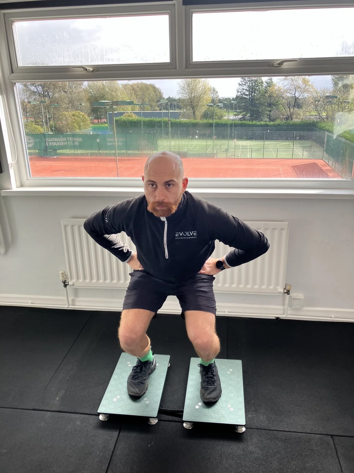 Athlete in the loading (countermovement) phase of a CMJ on VALD force plates at Evolve Physiotherapy, Swansea