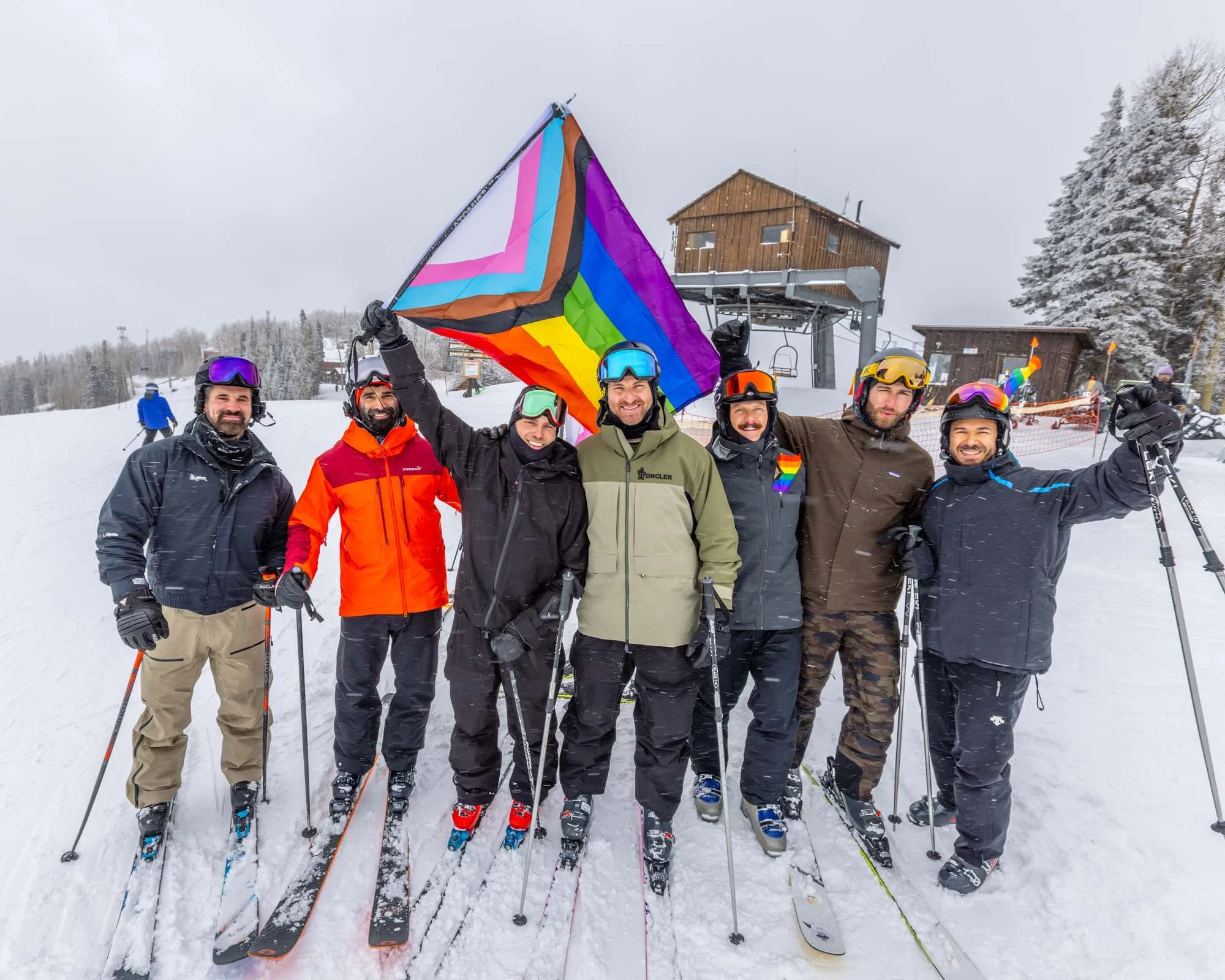 Skiers holding a rainbow flag at Telluride Gay Ski Week..jpg